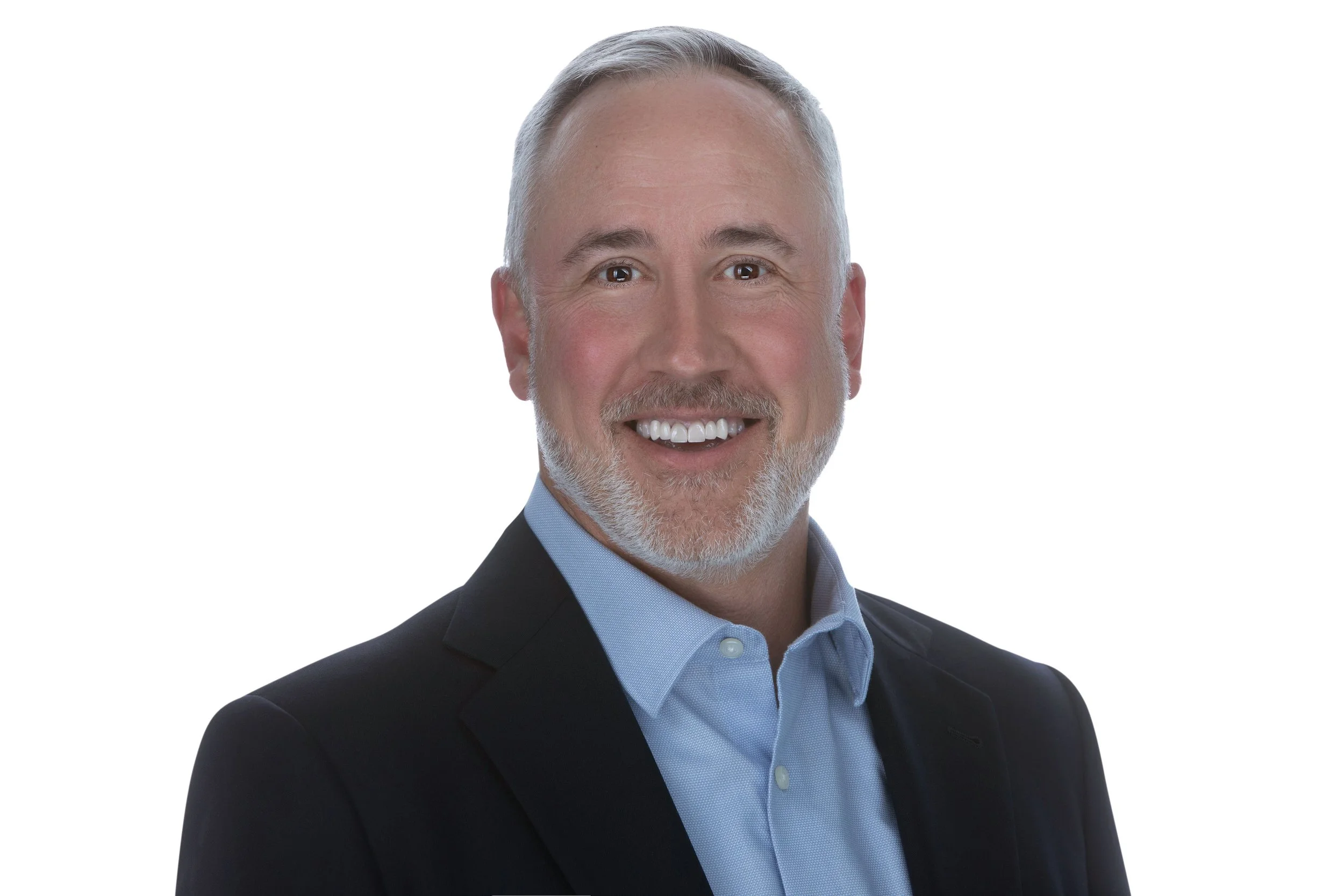 Marko Ungashick, CEO of Two West, smiling confidently in a black suit with a professional backdrop