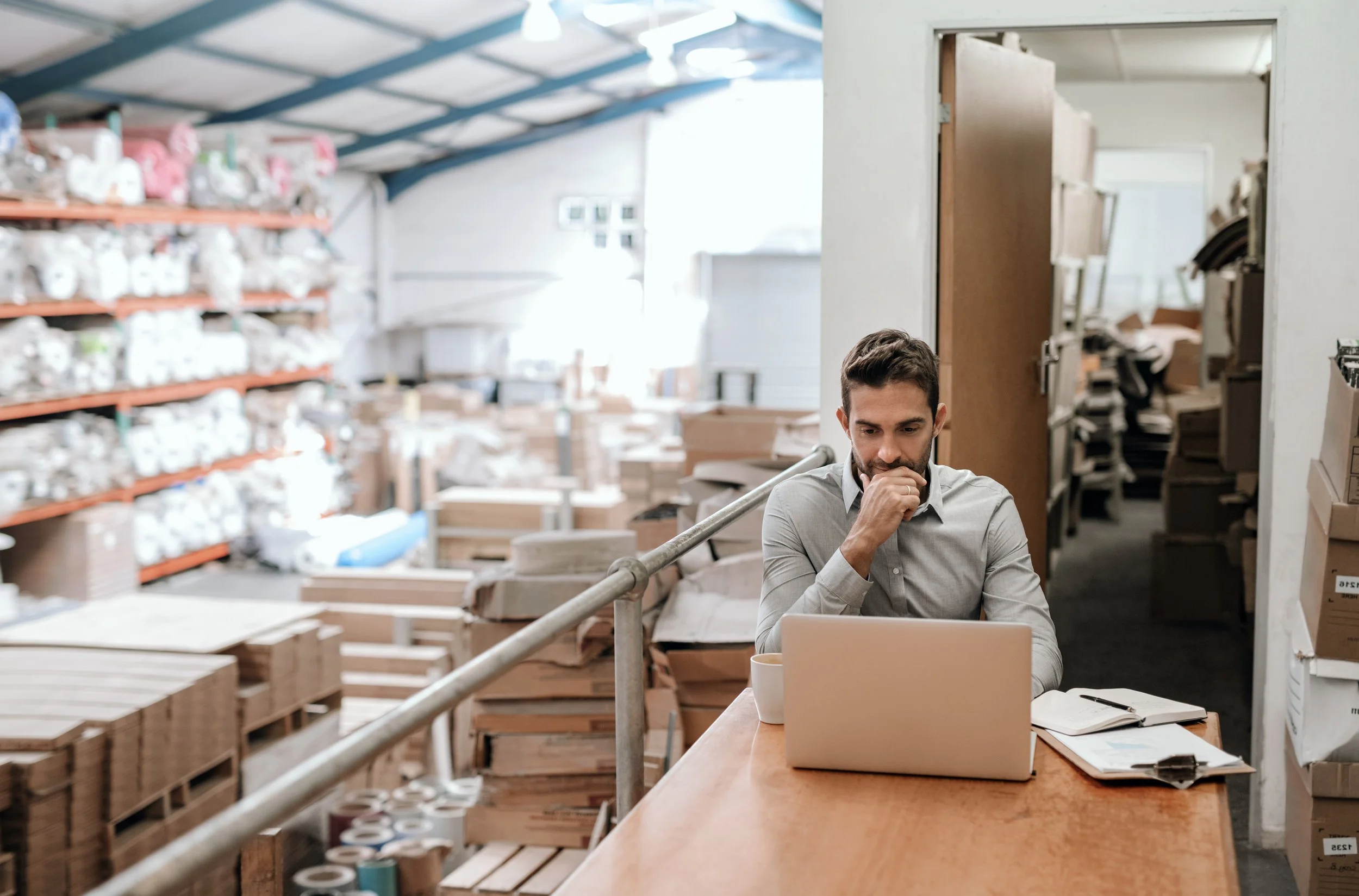 Manufacturing business owner reviewing communications strategy at his facility — PR and messaging services by Kwedar & Co.