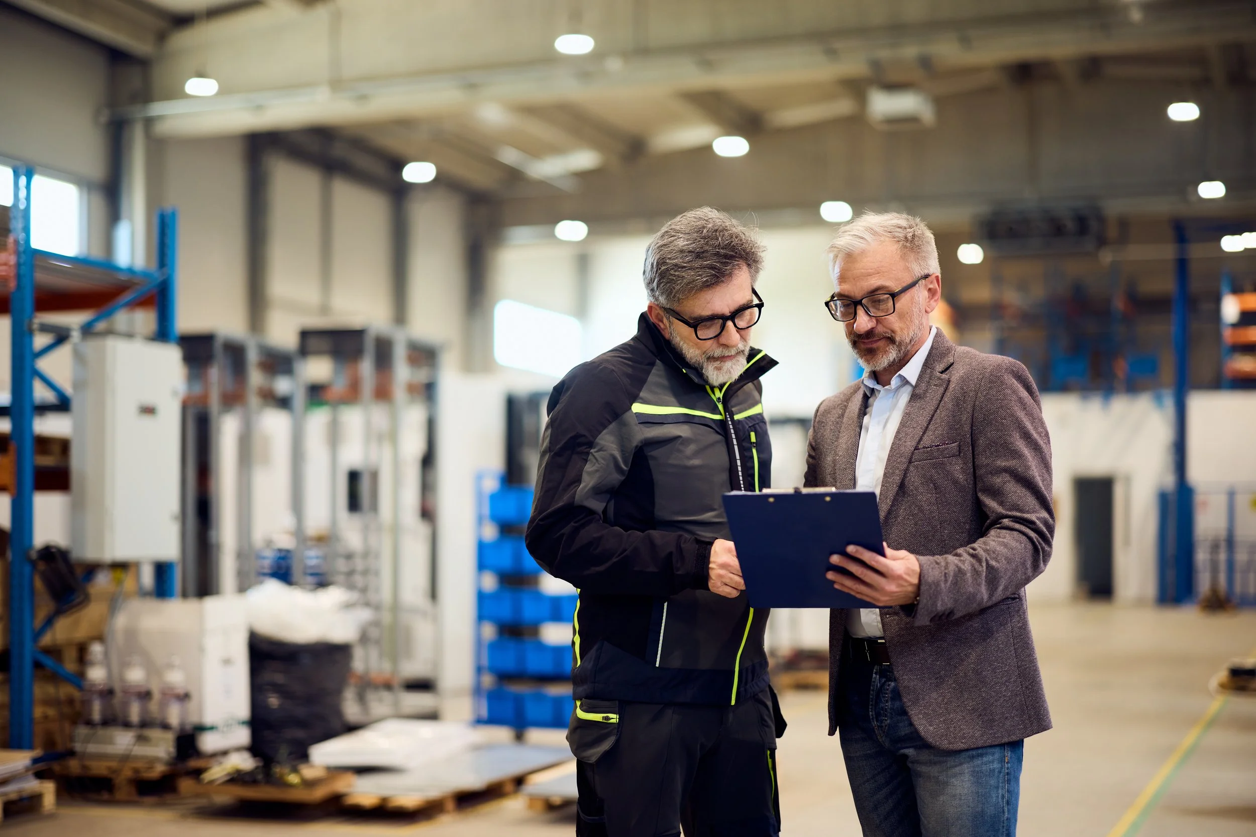 Manufacturing leader communicating strategy to team during uncertain business conditions