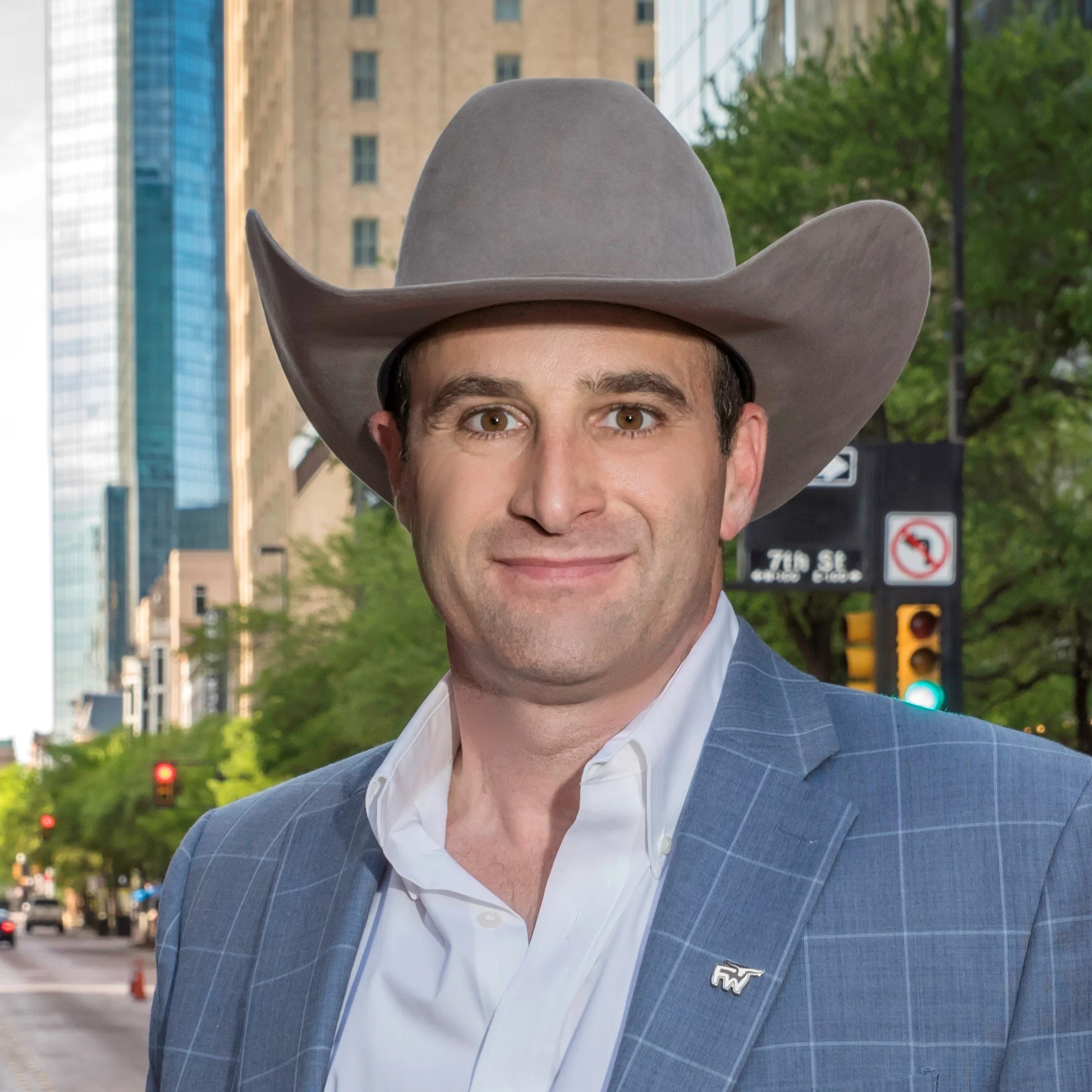 Mike Micallef in a cowboy hat, smiling