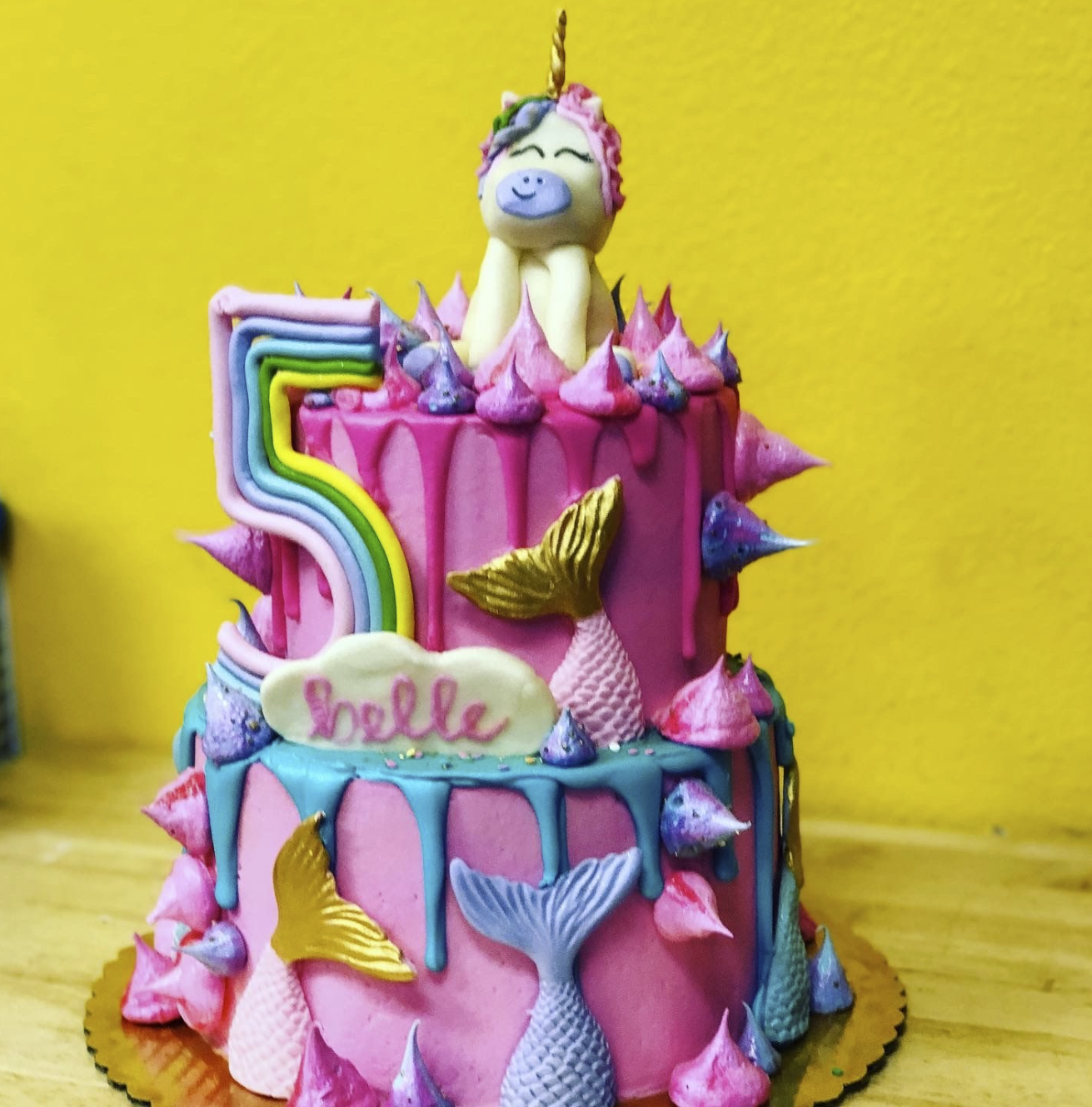 A colorful unicorn-mermaid-rainbow cake on a table, representing how specificity helps the right audience instantly recognize what they’re looking for.