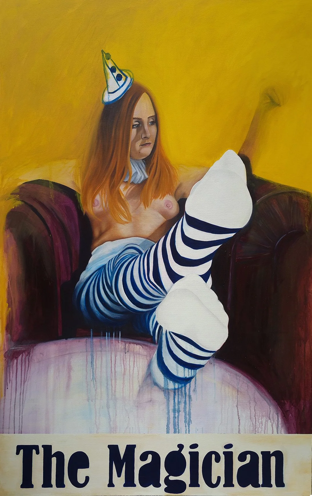 A painting of a topless woman with long red hair sitting on a purple armchair. She is wearing striped socks, shoes, and a party hat, with a yellow background. The words "The Magician" are written at the bottom.