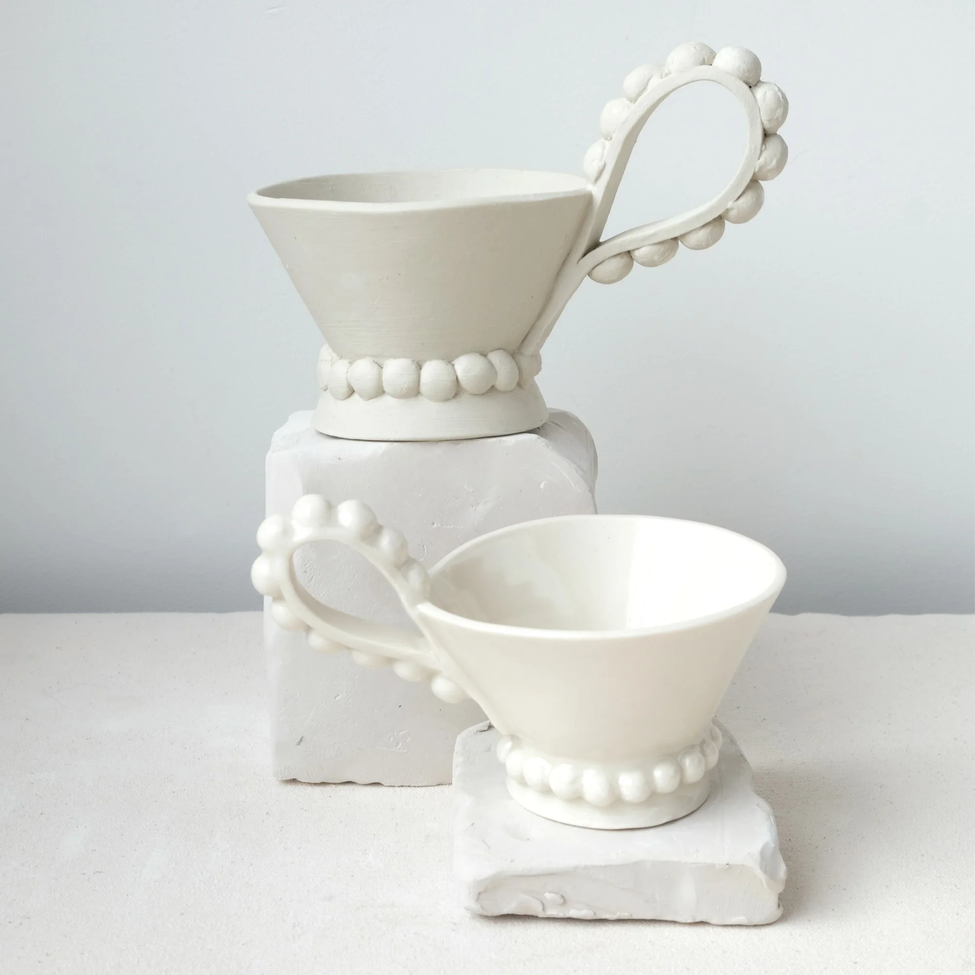 Beaded cup pottery template example showing raw clay and glazed ceramic cup for slab building