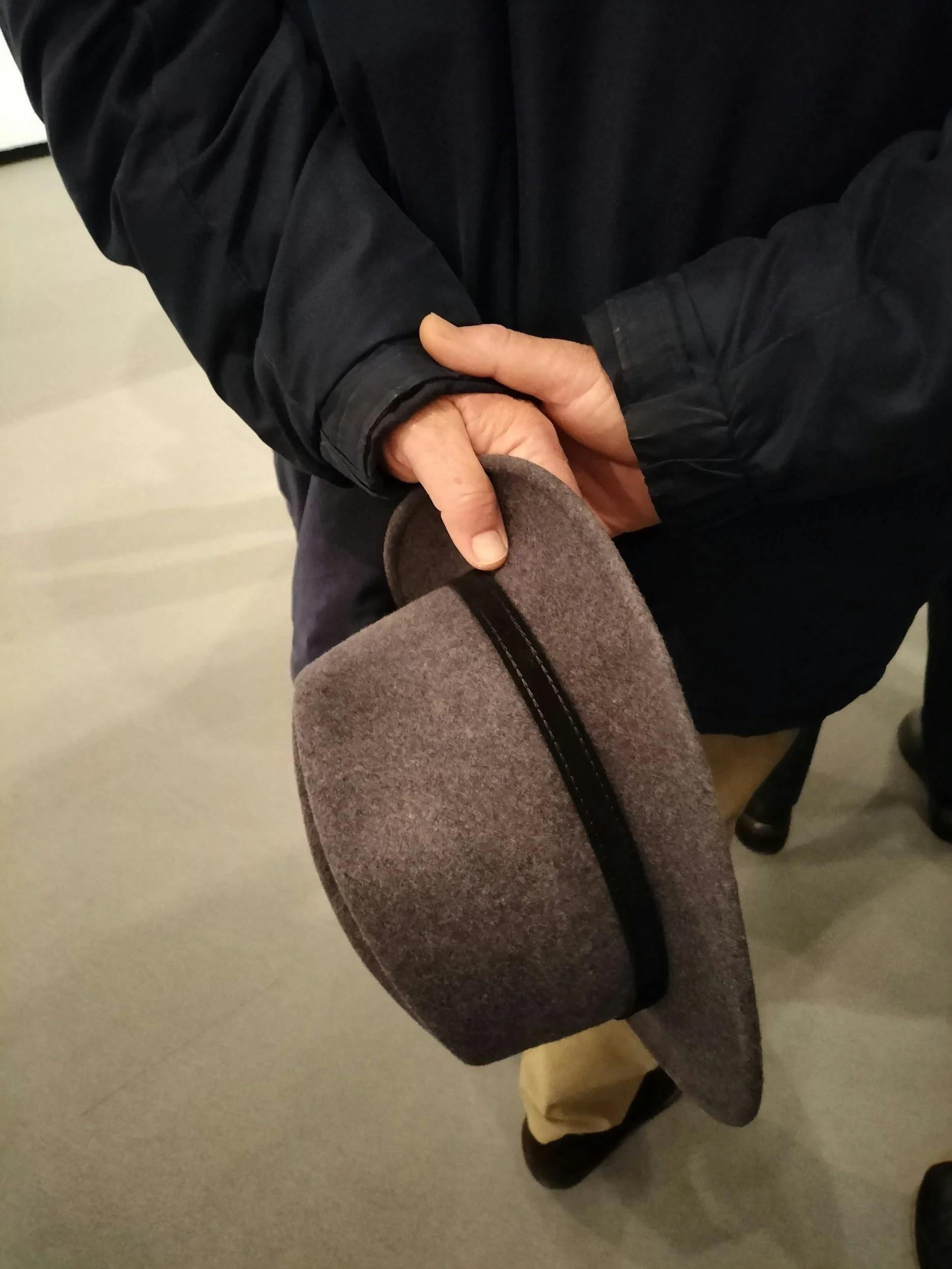 People remove their hats in respect as a funeral procession passes along