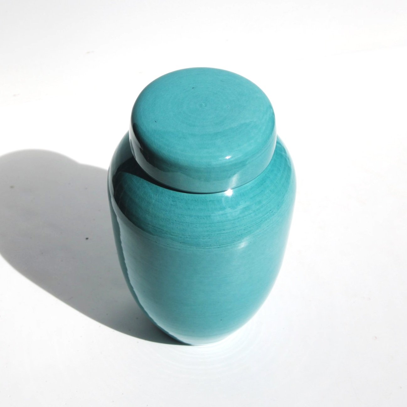 Bespoke ceramic urn with a hand-painted design, personalised to honour a loved one with a unique and meaningful tribute.