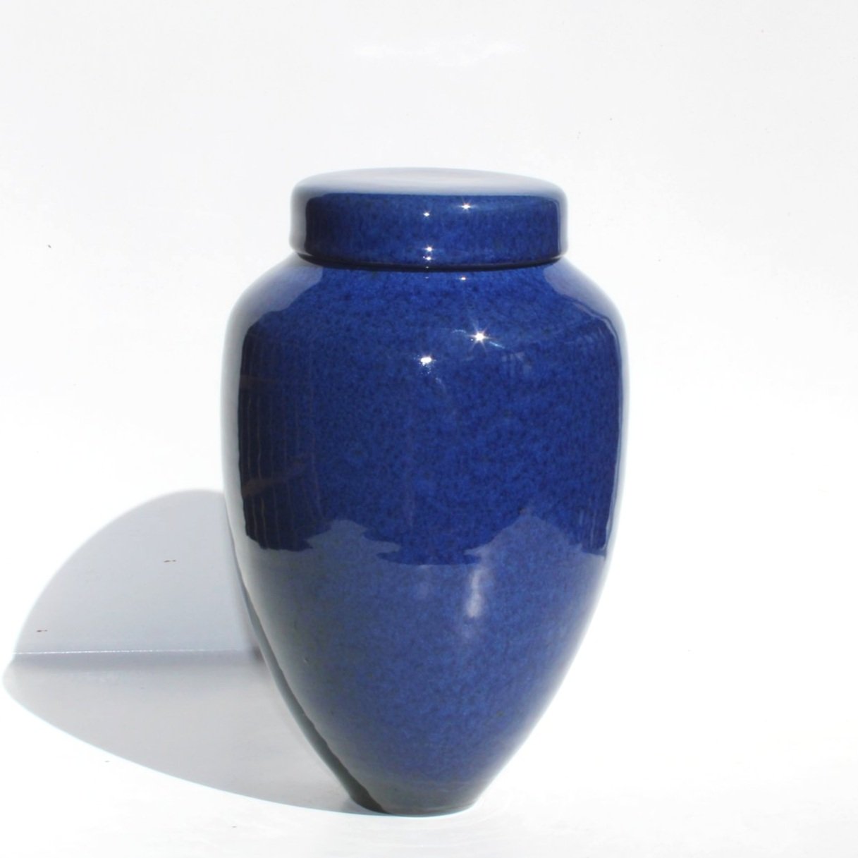 Bespoke ceramic urn with a hand-painted design, personalised to honour a loved one with a unique and meaningful tribute.