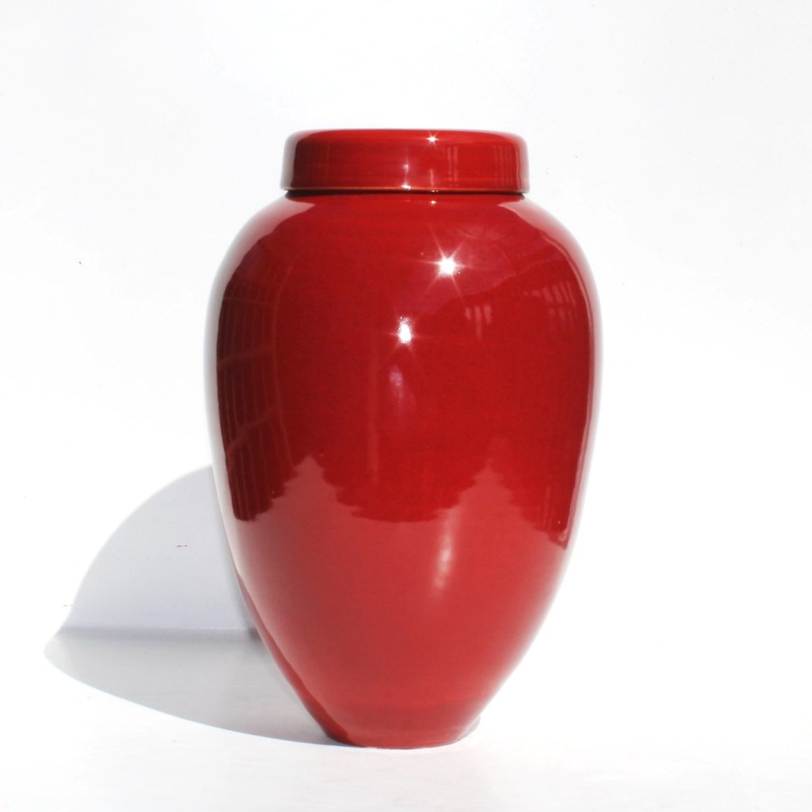 New Zealand handmade ceramic urn with a smooth, glossy glaze in deep blue tones, offering a timeless and elegant memorial option.