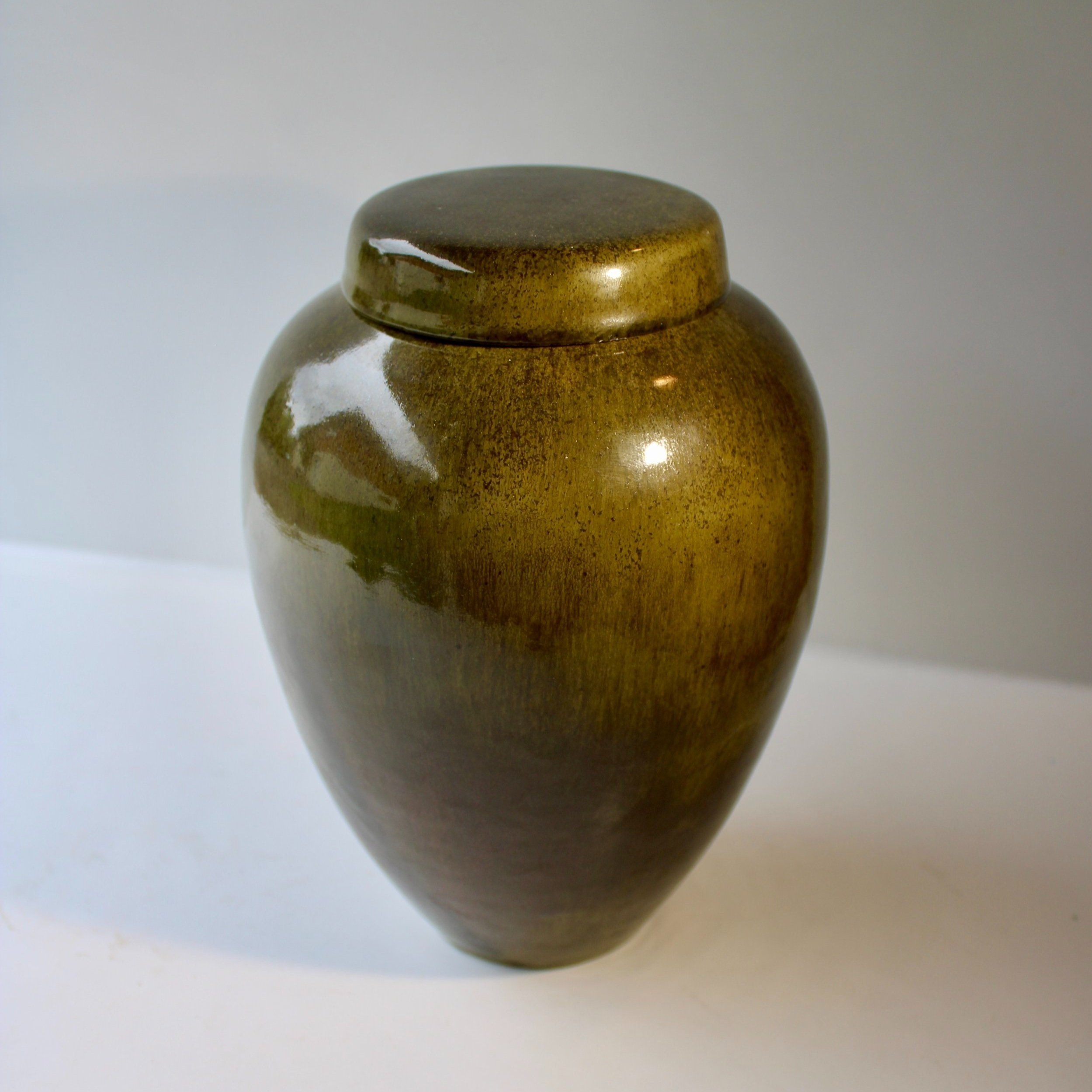Green ceramic urn inspired by Pounamu (New Zealand greenstone), featuring a rich satin finish and natural stone-like texture, made in Auckland.