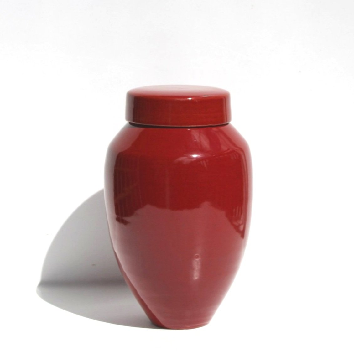 Handmade ceramic urn with unique crackle patterns and earthy tones, crafted in Auckland, New Zealand.