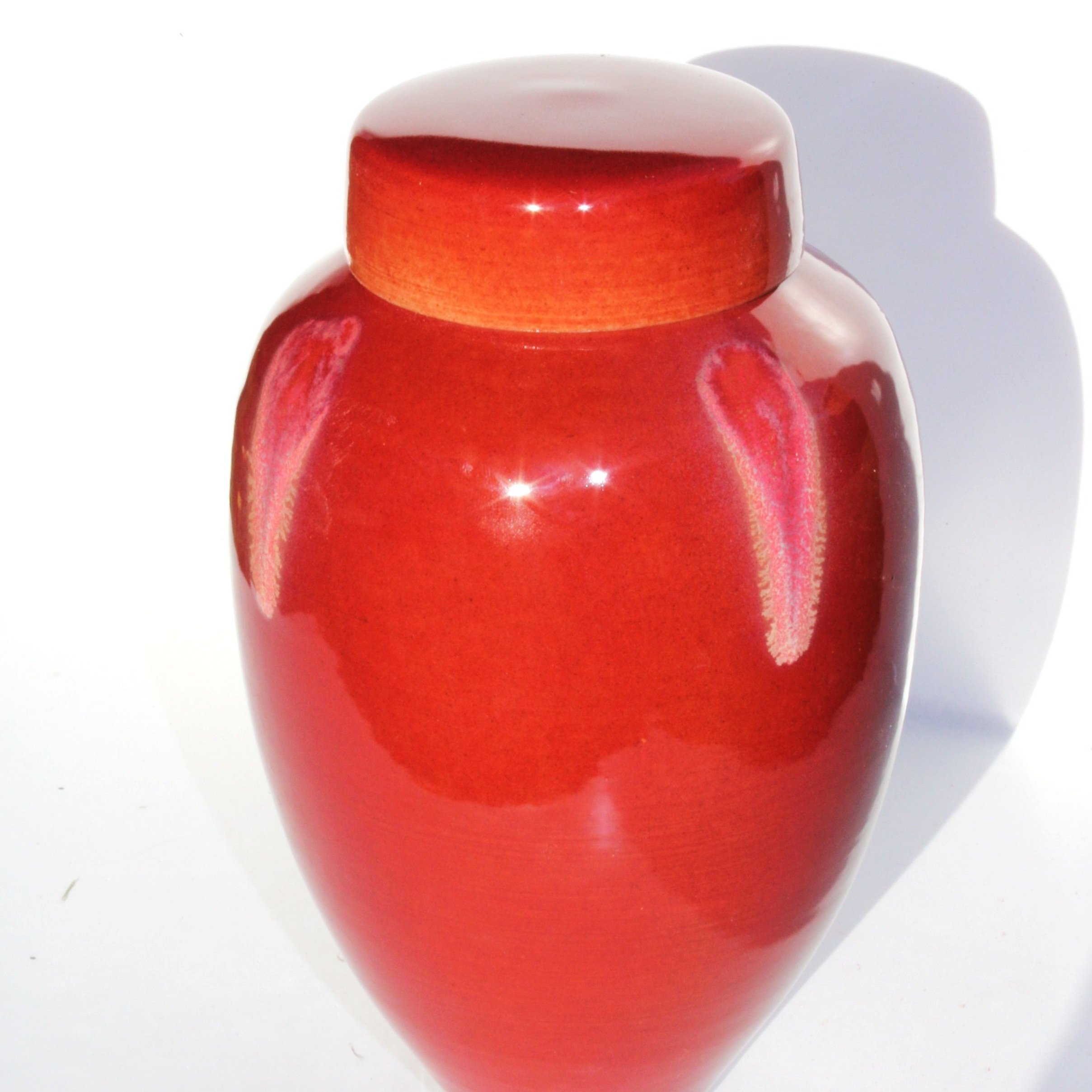 Unique ceramic urn with a crystal-effect glaze, showcasing intricate formations and rich variegated colors for a one-of-a-kind memorial piece.