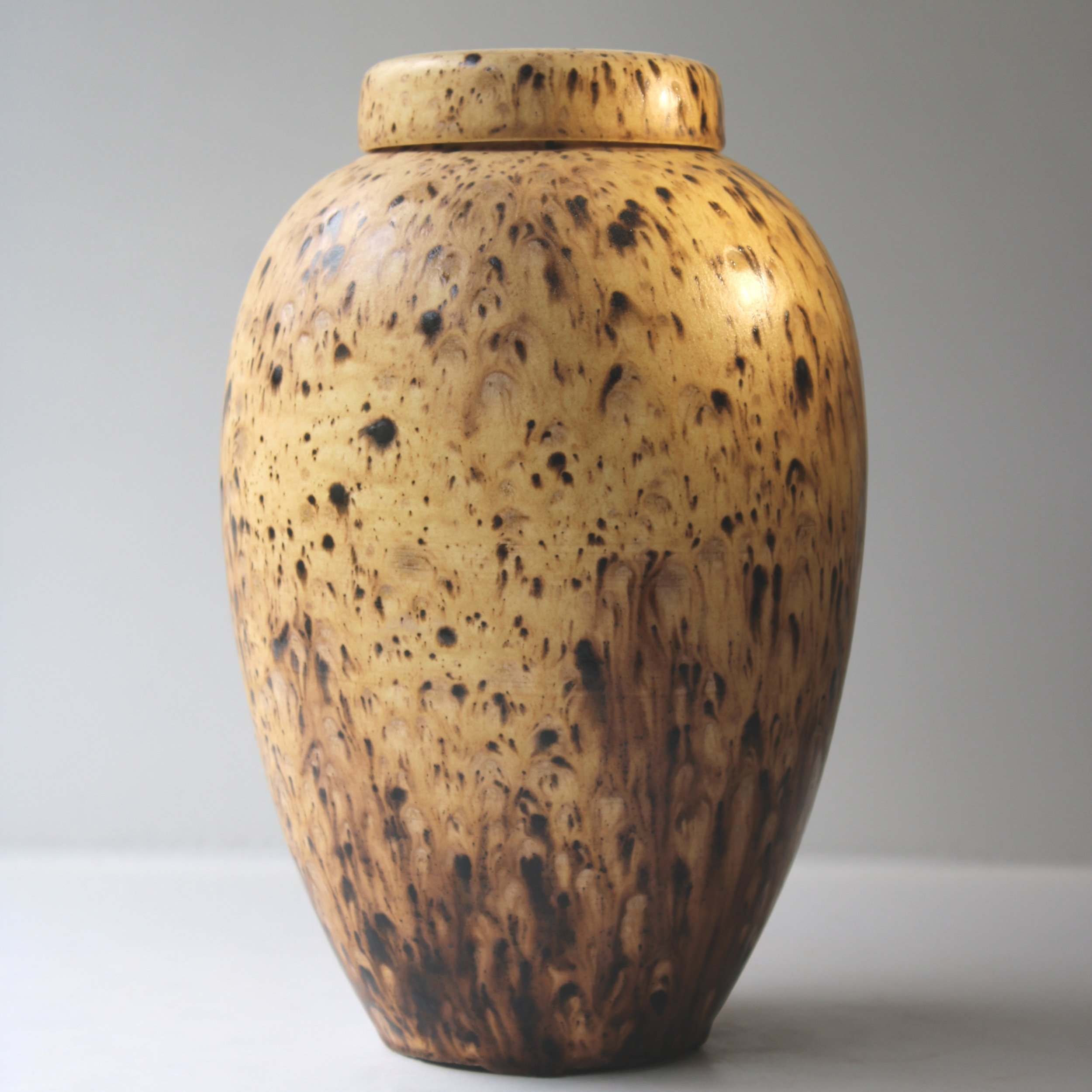 Unique ceramic urn with a crystal-effect glaze, showcasing intricate formations and rich variegated colors for a one-of-a-kind memorial piece.
