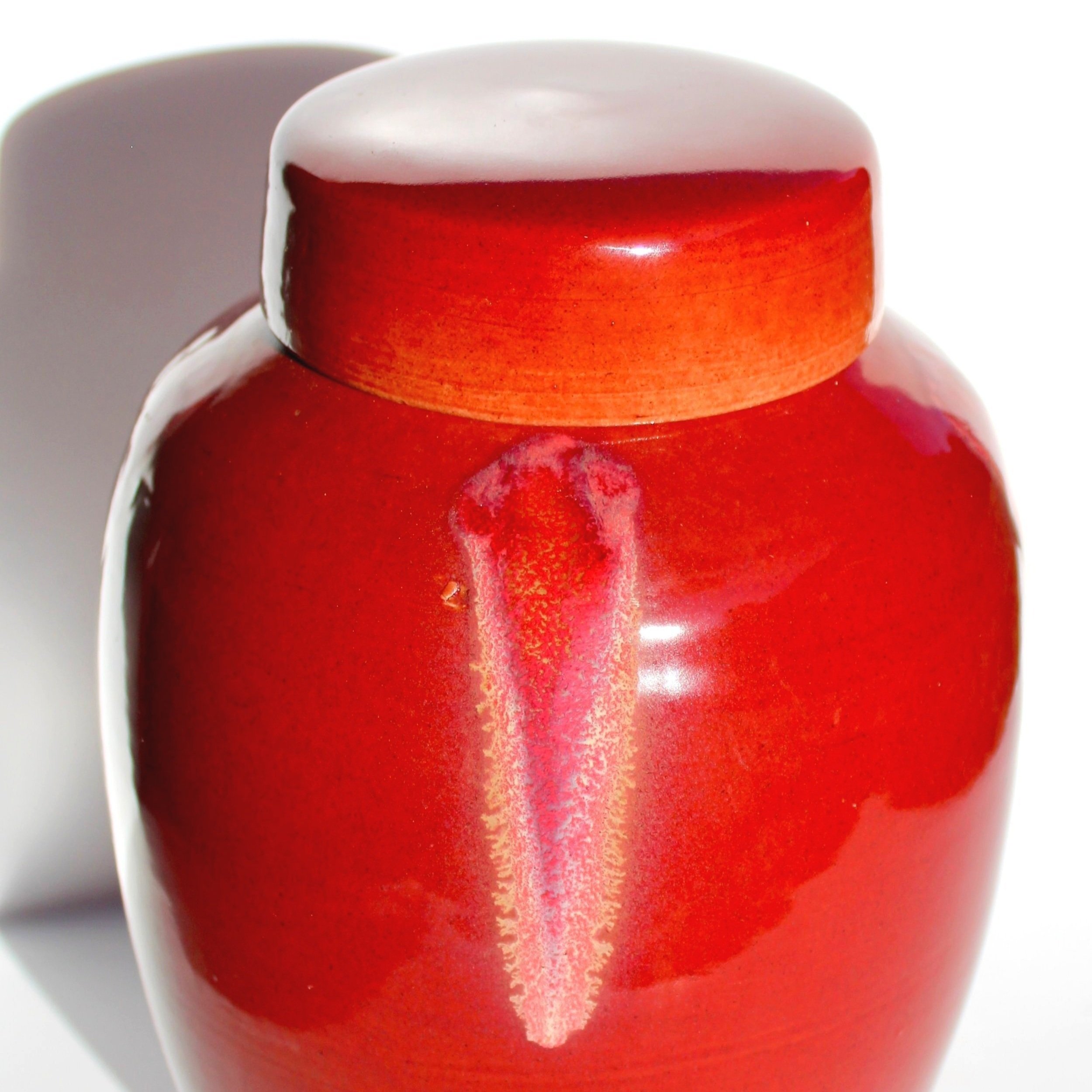 New Zealand handmade ceramic urn with a smooth, glossy glaze in deep blue tones, offering a timeless and elegant memorial option.