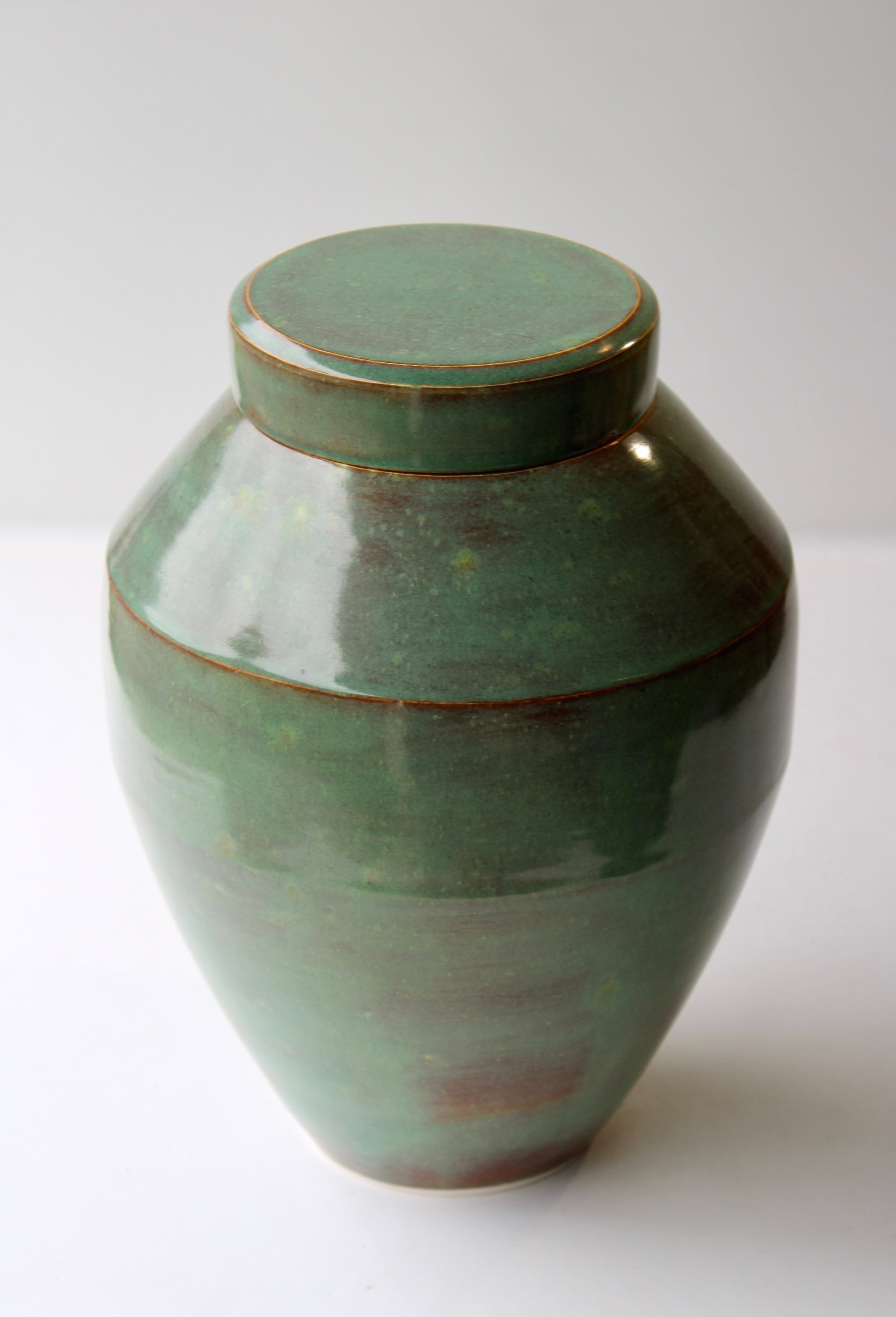 New Zealand handmade ceramic urn with a smooth, glossy glaze in deep blue tones, offering a timeless and elegant memorial option.