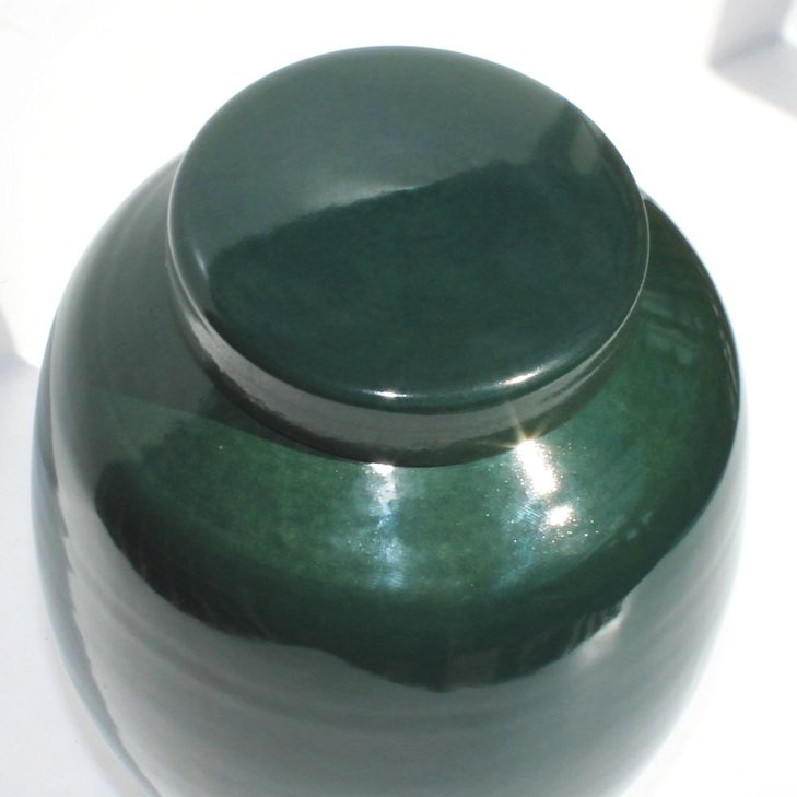 Green ceramic urn inspired by Pounamu (New Zealand greenstone), featuring a rich satin finish and natural stone-like texture, made in Auckland.