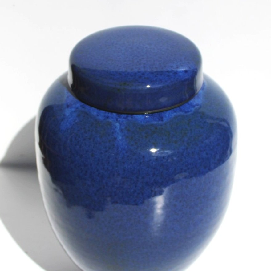 Bespoke ceramic urn with a hand-painted design, personalised to honour a loved one with a unique and meaningful tribute.