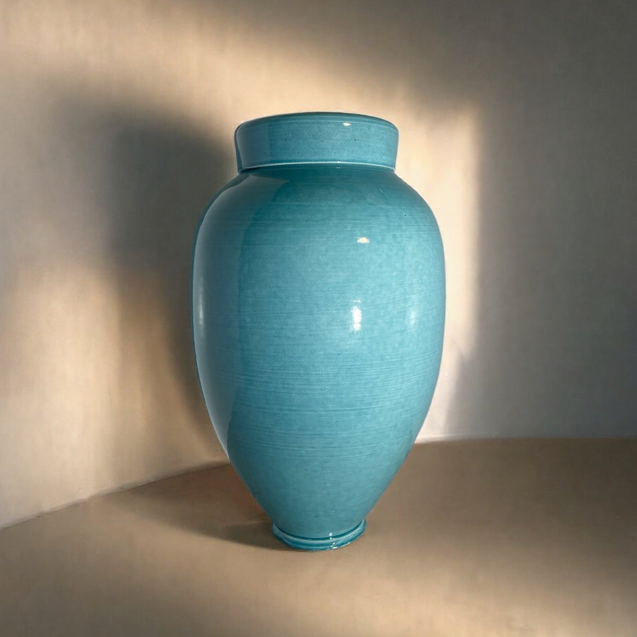 New Zealand handmade ceramic urn with a smooth, glossy glaze in deep blue tones, offering a timeless and elegant memorial option.