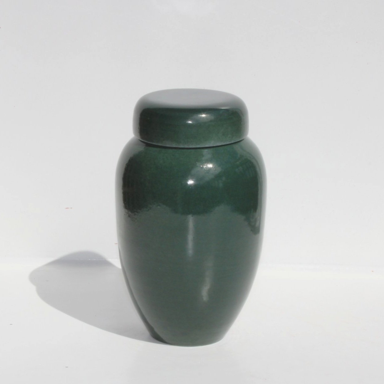 Green ceramic urn inspired by Pounamu (New Zealand greenstone), featuring a rich satin finish and natural stone-like texture, made in Auckland.