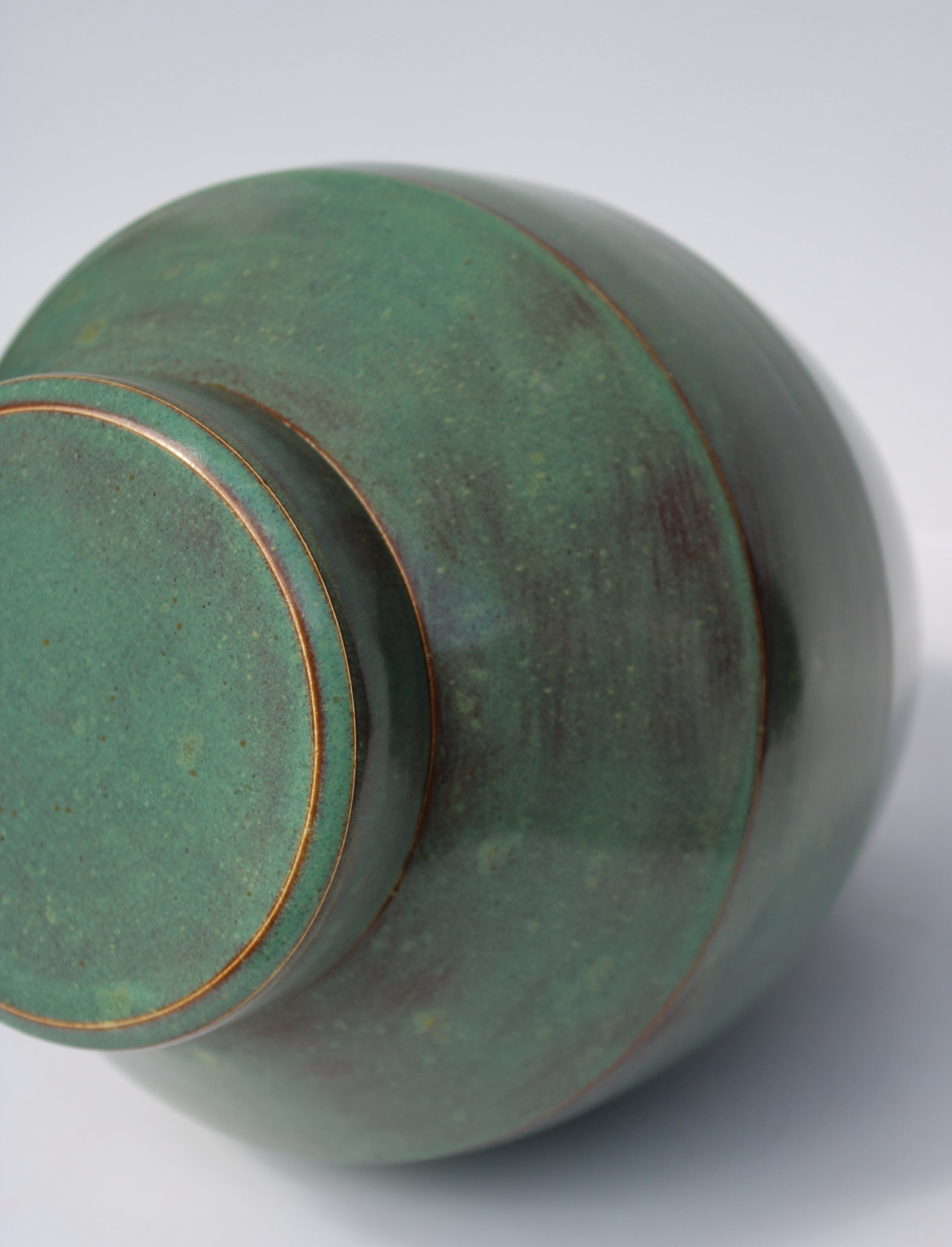 Green ceramic urn inspired by Pounamu (New Zealand greenstone), featuring a rich satin finish and natural stone-like texture, made in Auckland.