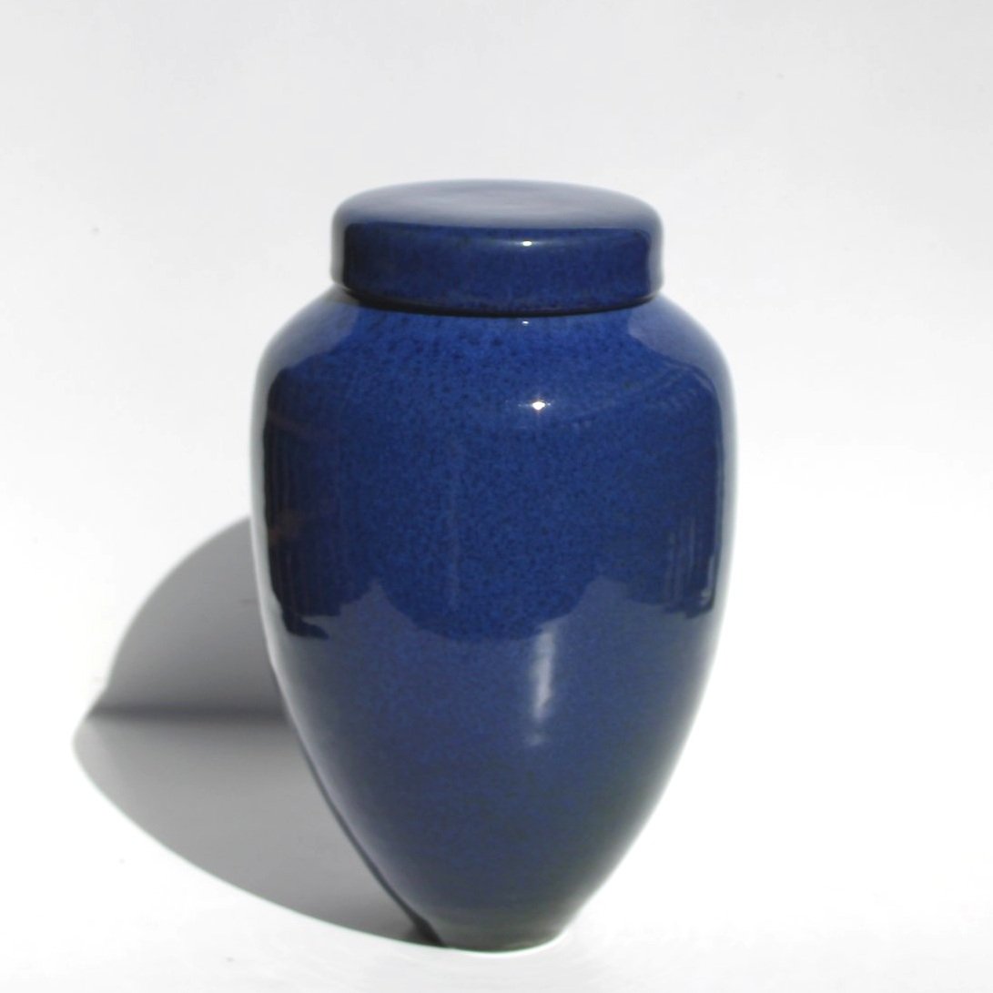 Handmade ceramic urn with unique crackle patterns and earthy tones, crafted in Auckland, New Zealand.