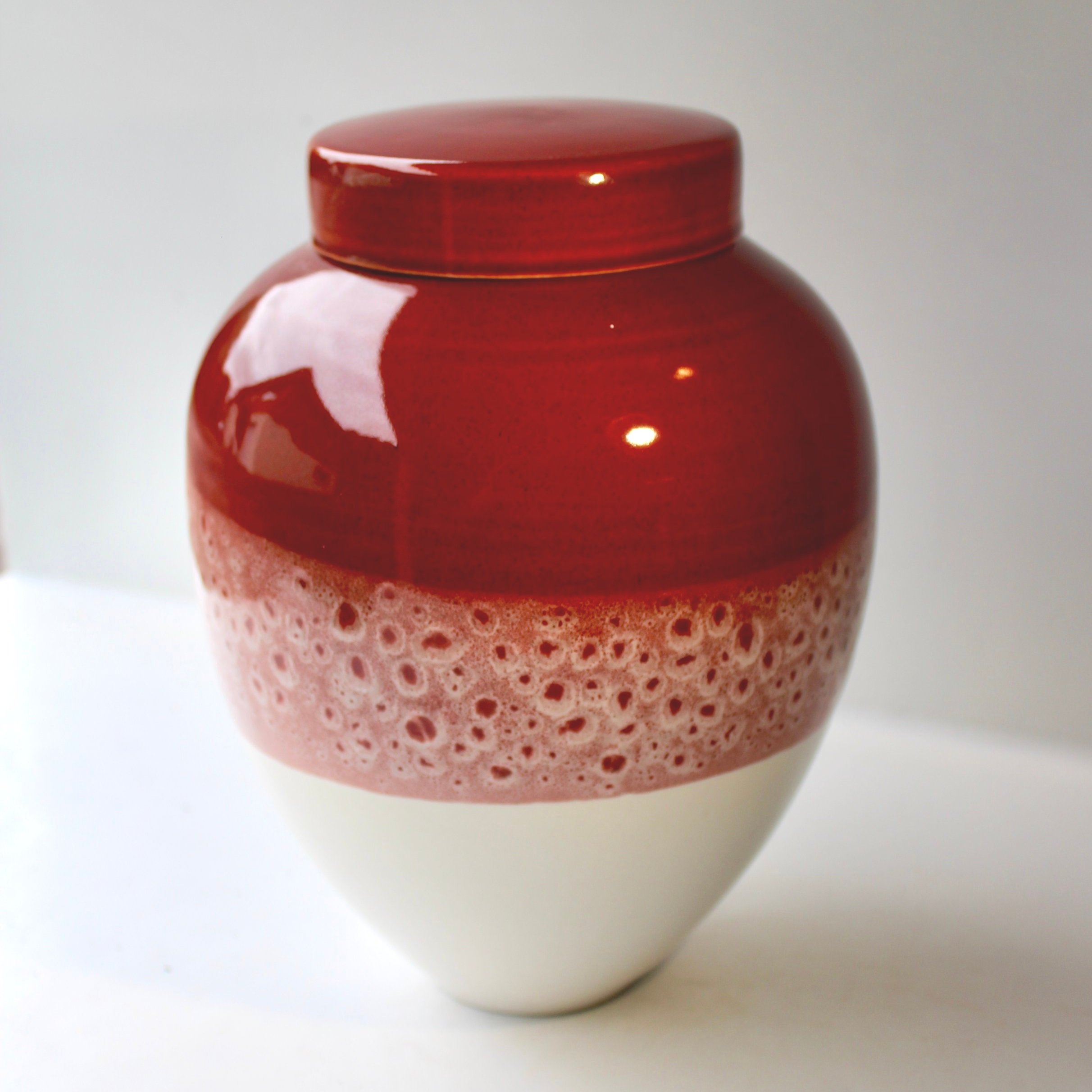 Artisan ceramic urn with a speckled glaze and organic texture, offering a natural and rustic aesthetic.made in Auckland.