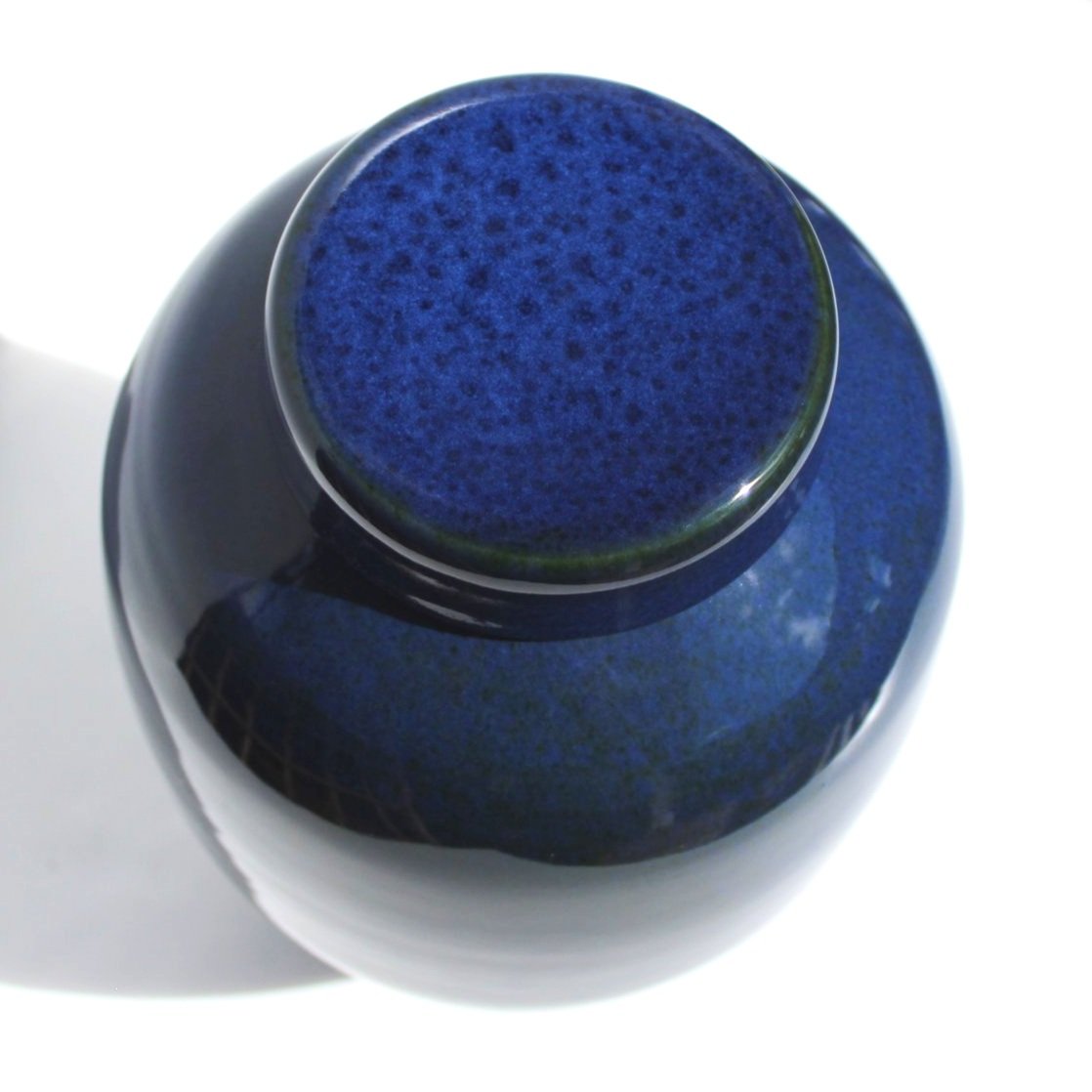 New Zealand handmade ceramic urn with a smooth, glossy glaze in deep blue tones, offering a timeless and elegant memorial option.