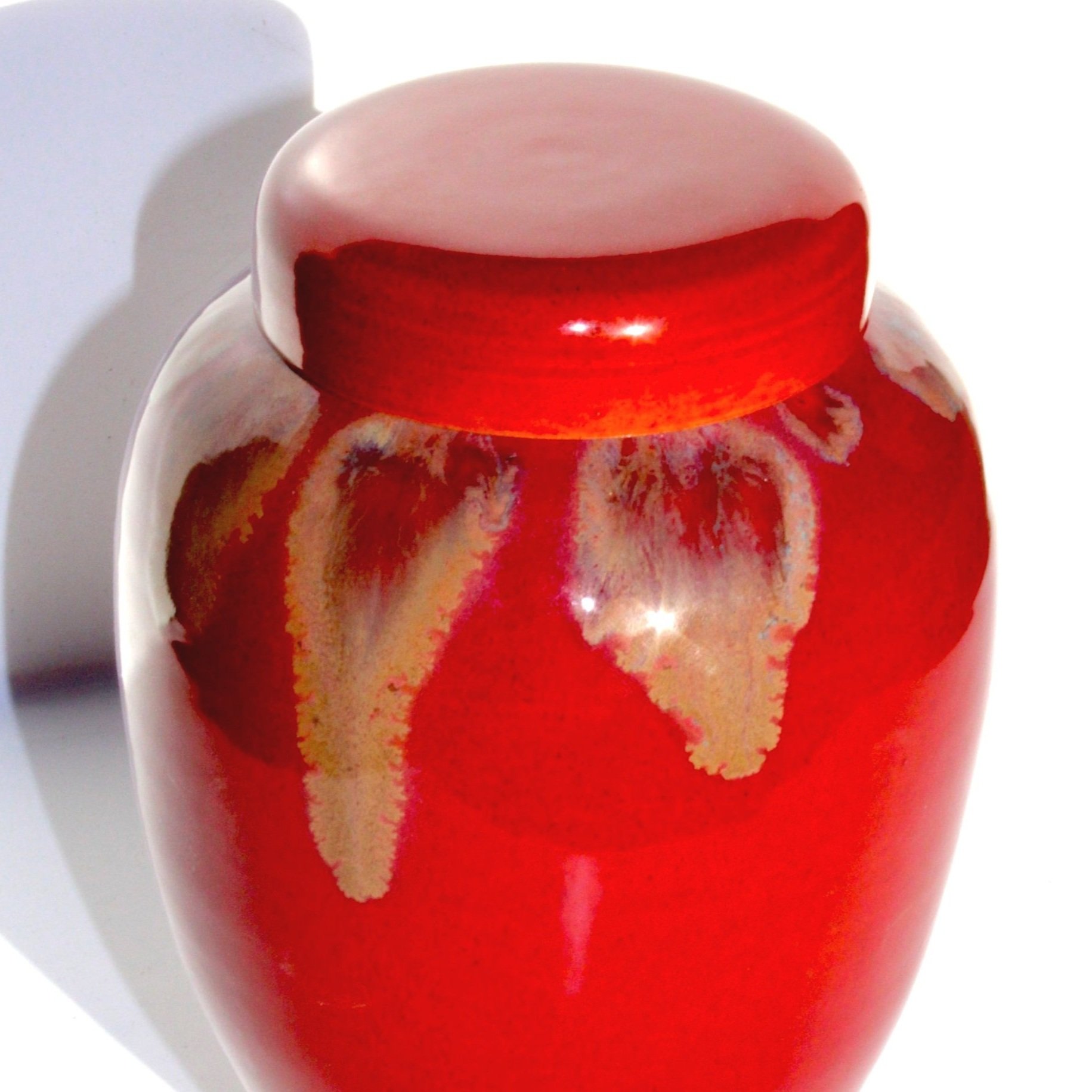 Unique ceramic urn with a crystal-effect glaze, showcasing intricate formations and rich variegated colors for a one-of-a-kind memorial piece.