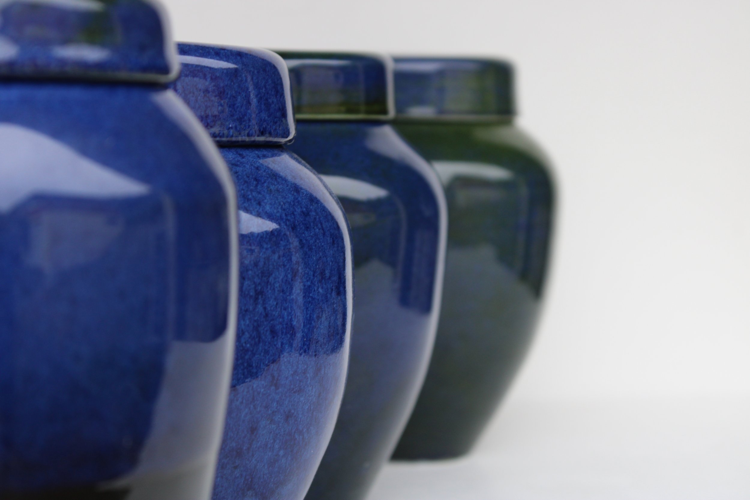 New Zealand handmade ceramic urn with a smooth, glossy glaze in deep blue tones, offering a timeless and elegant memorial option.