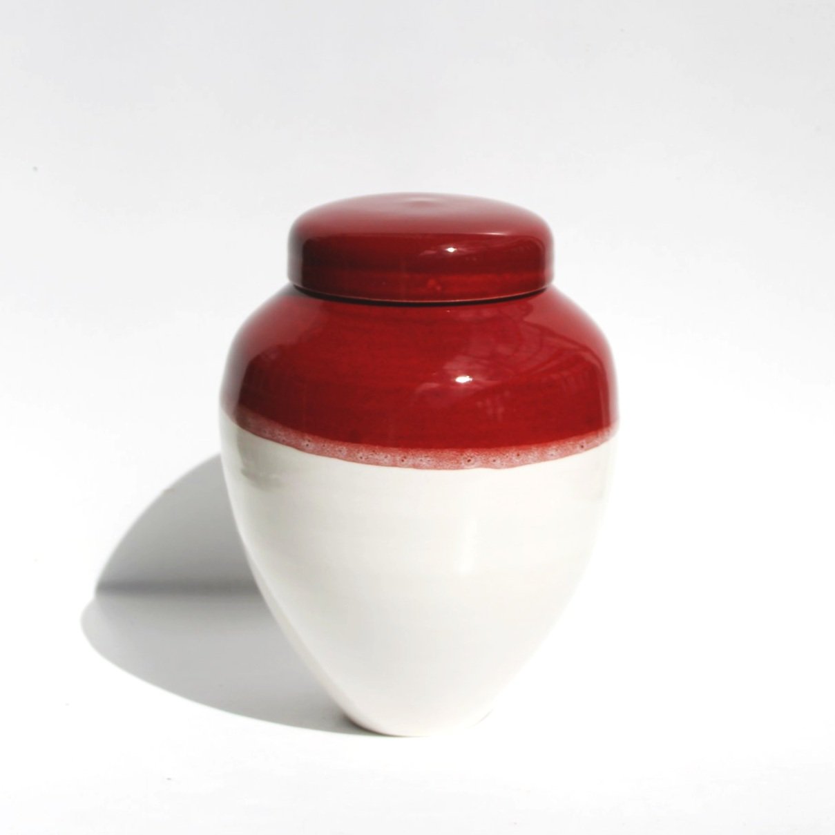 Artisan ceramic urn with a speckled glaze and organic texture, offering a natural and rustic aesthetic.