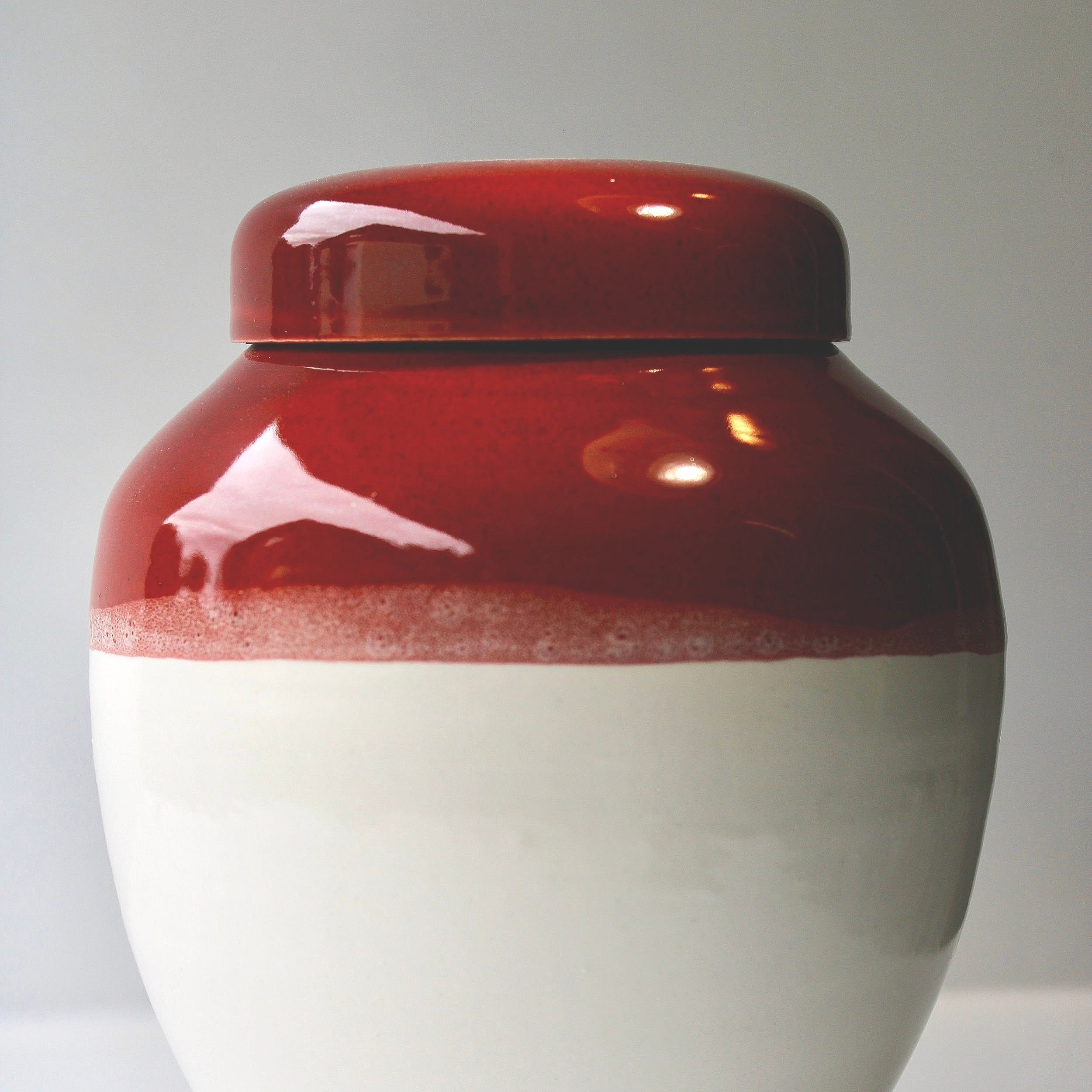 New Zealand handmade ceramic urn with a smooth, glossy glaze in deep blue tones, offering a timeless and elegant memorial option.
