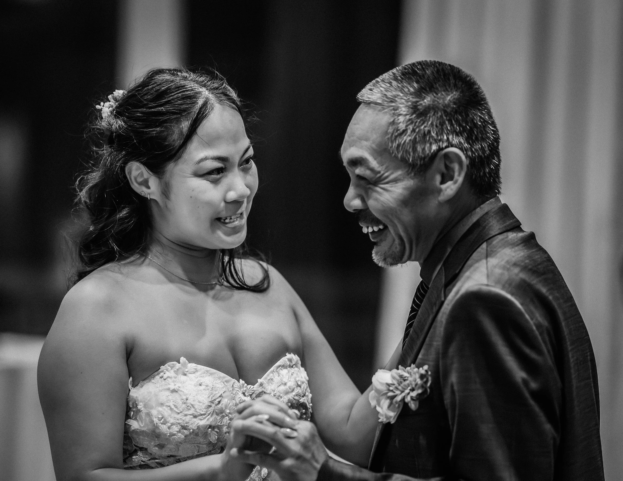 A woman in a strapless wedding dress and a man in a suit are smiling and dancing together, sharing a joyful moment. engagement wedding photographer phoenix az engagement photographer az traveling wedding photographer az