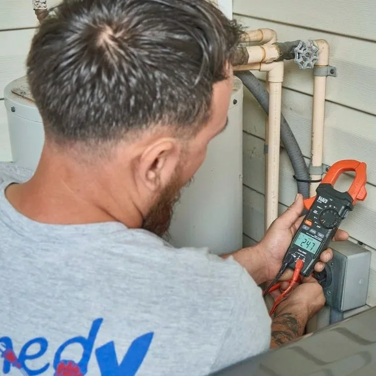 Technician measuring grounding and bonding at exterior electrical equipment, verifying main bonding jumper function and electrical safety compliance.