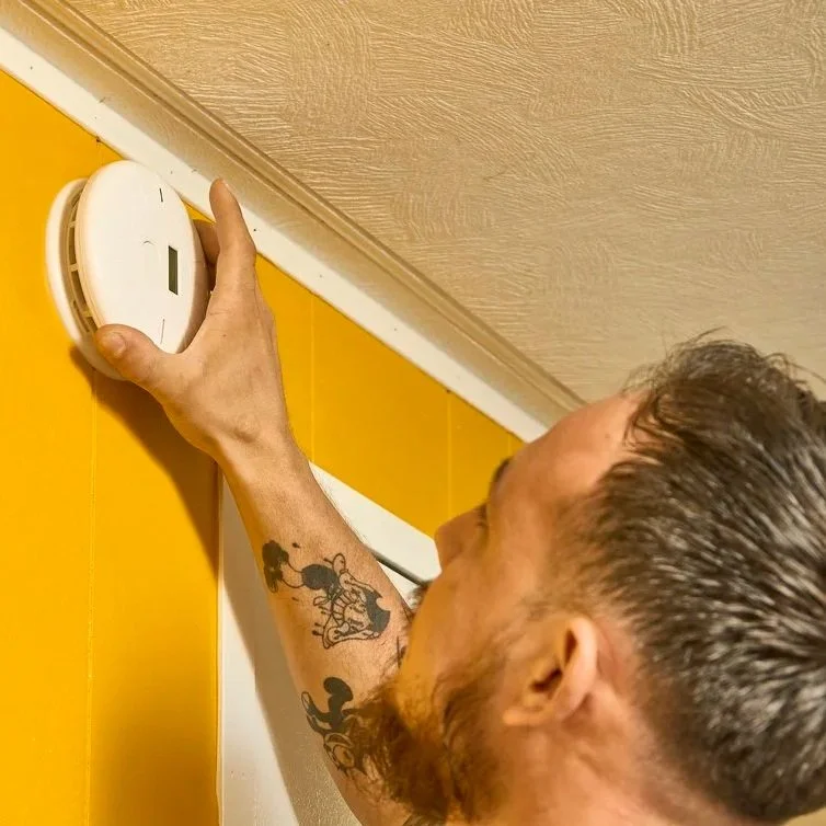 Technician fitting recessed LED ceiling lights showing electrical upgrade that enhances room illumination and reduces dependence on bulky fixtures.