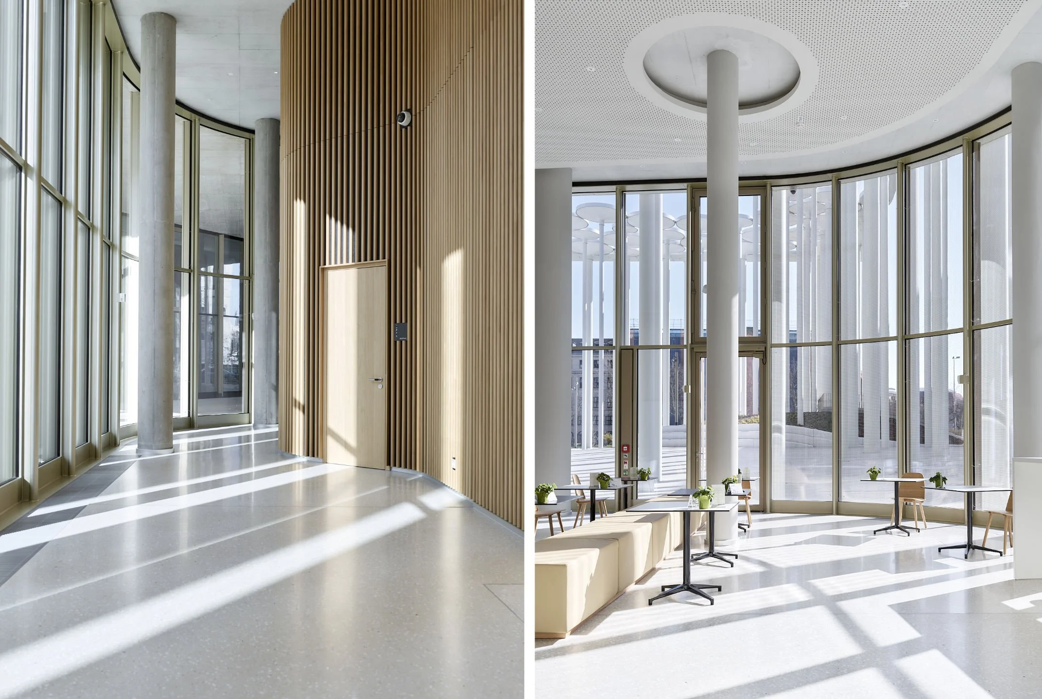 Innenraum mit großen Fenstern, sonniger Blick nach draußen, moderner architektur, Holz- und Betonelemente, elegante Einrichtung mit Tischen und Stühlen.