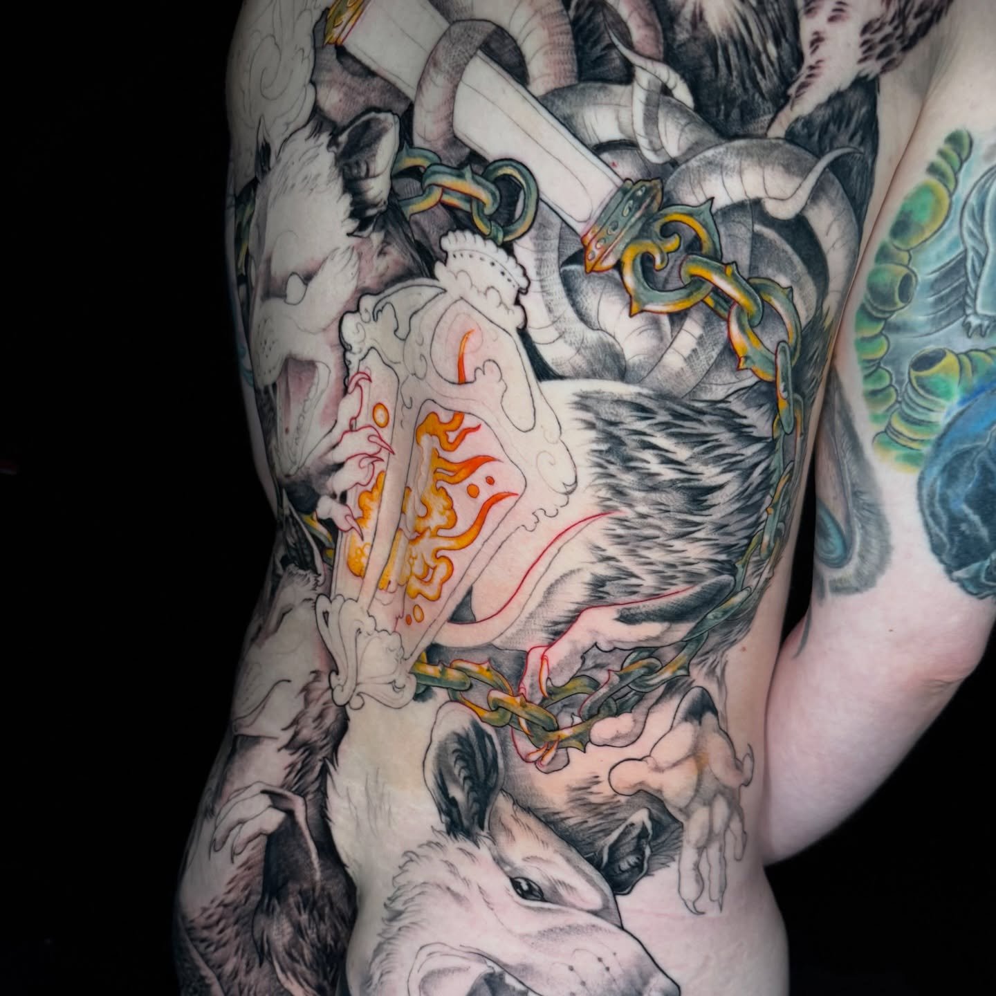 some progress on this opossum king back piece 🫶 we started colour&mdash; just the chains &amp; some fire for now, but excited to get into the little individual guys next time! #opossum #backpiece #tattoo