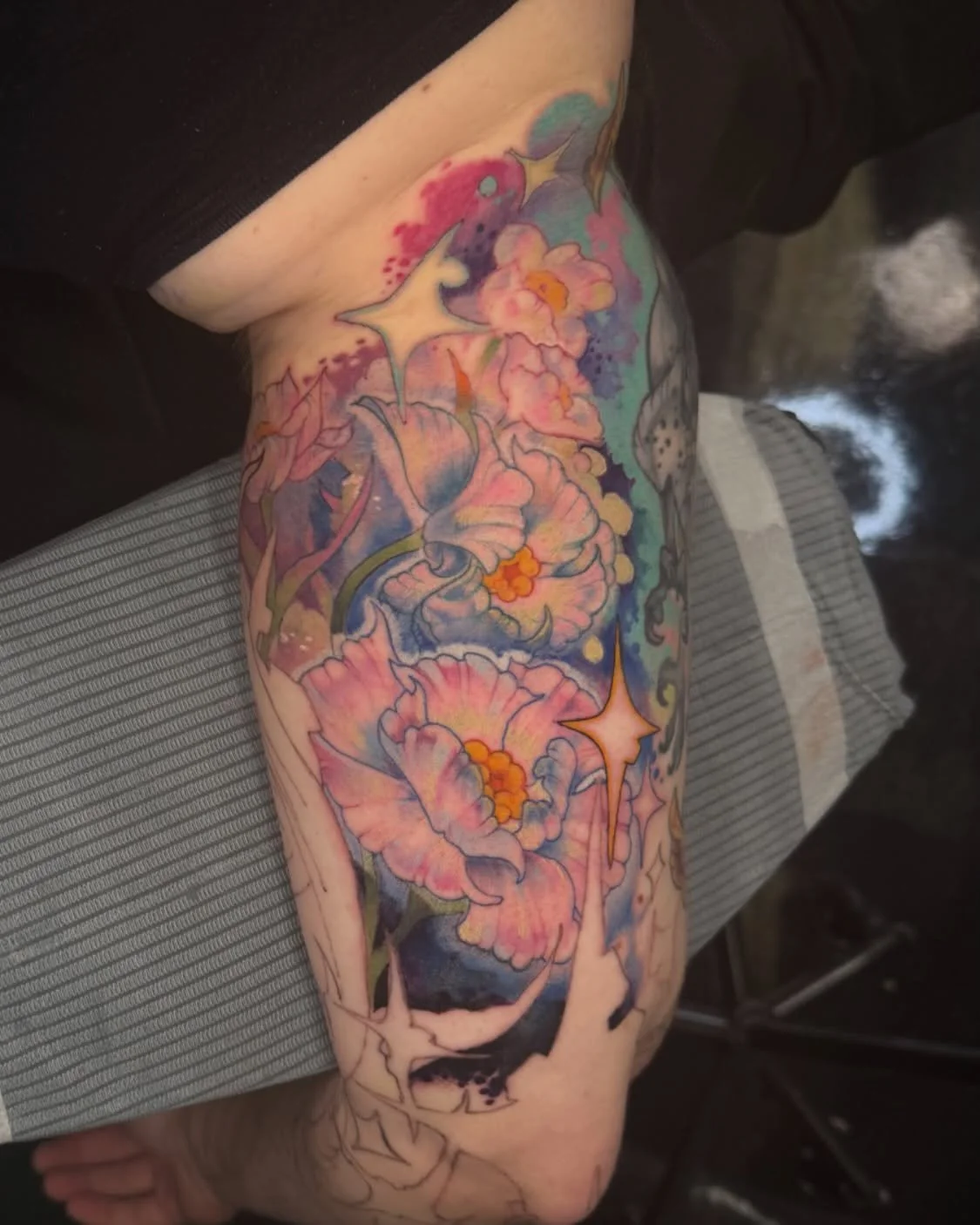 part of a starbird (ff14) sleeve &mdash; we greylined the rest &amp; shaded some less than 2 weeks ago so i didn&rsquo;t want to go into still healing skin, but left enough space to add these elpis flowers &amp; go all in on colour. excited for the n