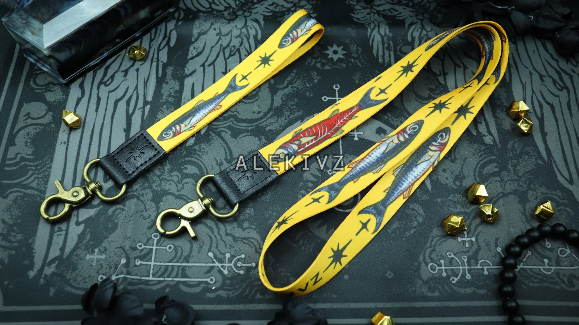 Example of both wrist and neck lanyard designs. Features an alive sardine on one side and fileted one on the other side, with a lobster clasp attached with a reinforced piece of faux leather. 