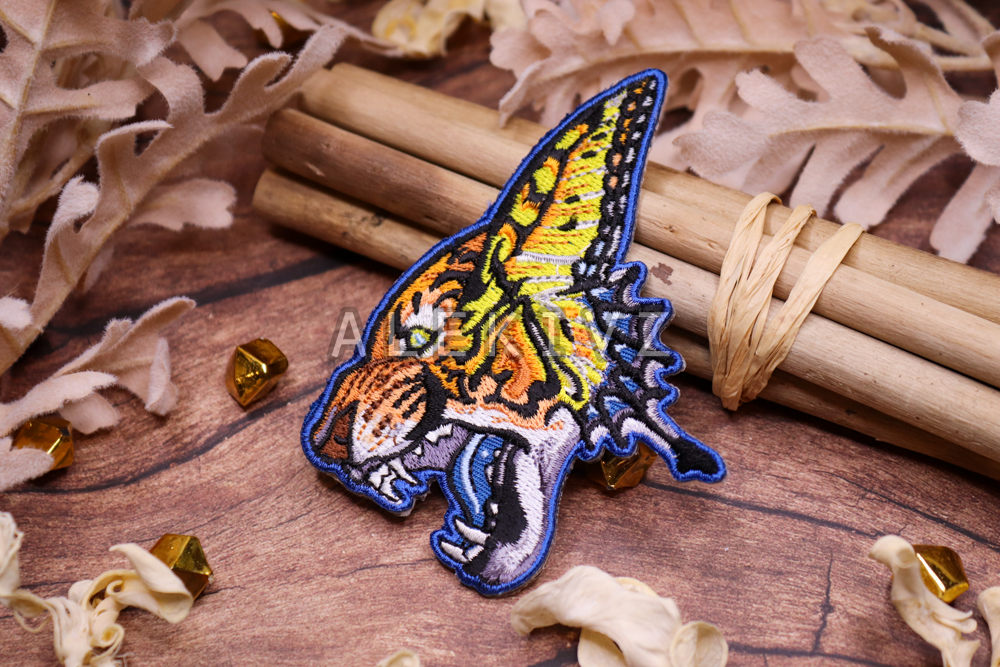 Example of embroidered patch design of a "tiger swallowtail," combining the iconic Eastern tiger swallowtail butterfly & its tiger namesake. Features heavy embroidery in a small space. 