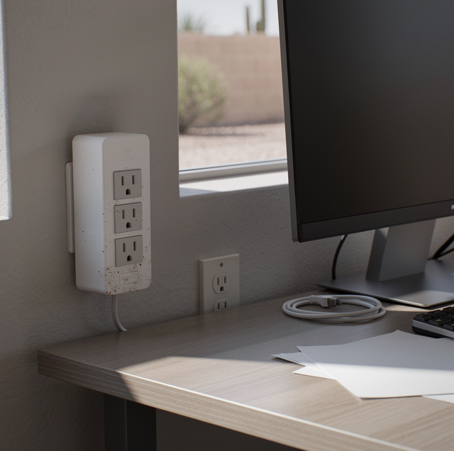 surge protector and power strip side by side on desk