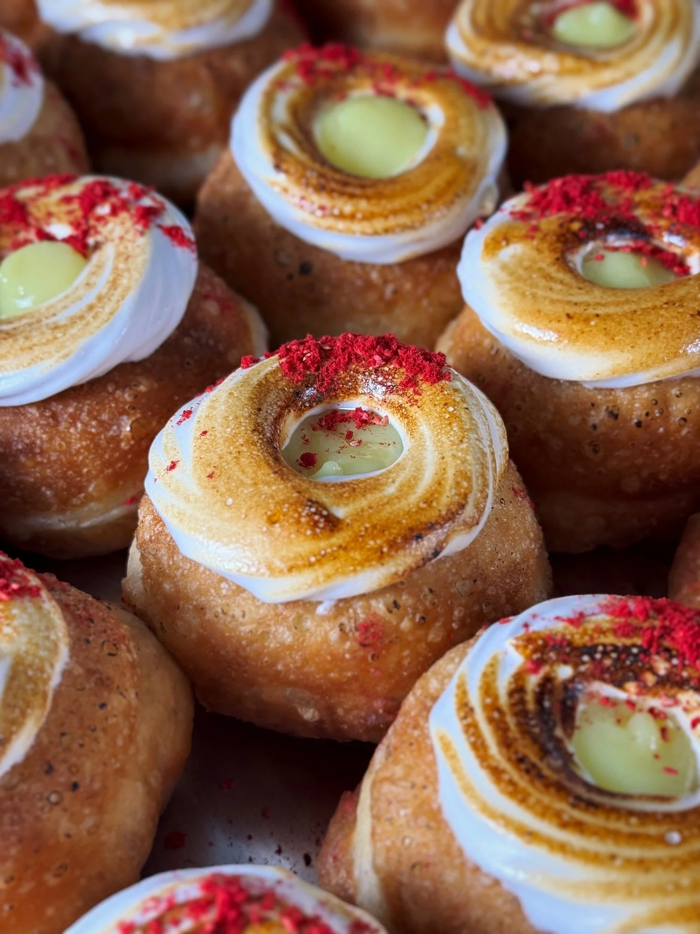 Lemon Meringue Donut - always taking me back to my childhood and my nonnas&rsquo; making lemon meringue pies 🍋💛

Filled with lemon curd and vanilla custard, topped with decadent, pillowy torched meringue and freeze-dried raspberry powder.

This one