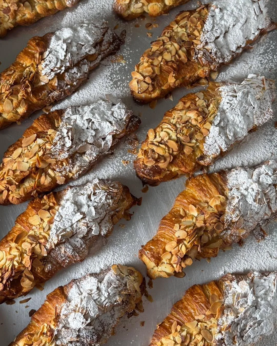 Almond Croissant ✨ Buttery layers of pastry brushed with vanilla syrup, filled and topped with almond cream (aka frangipane) and finished with sliced almonds. 
Did you know that a good croissant takes three days to make? It&rsquo;s a long process, bu