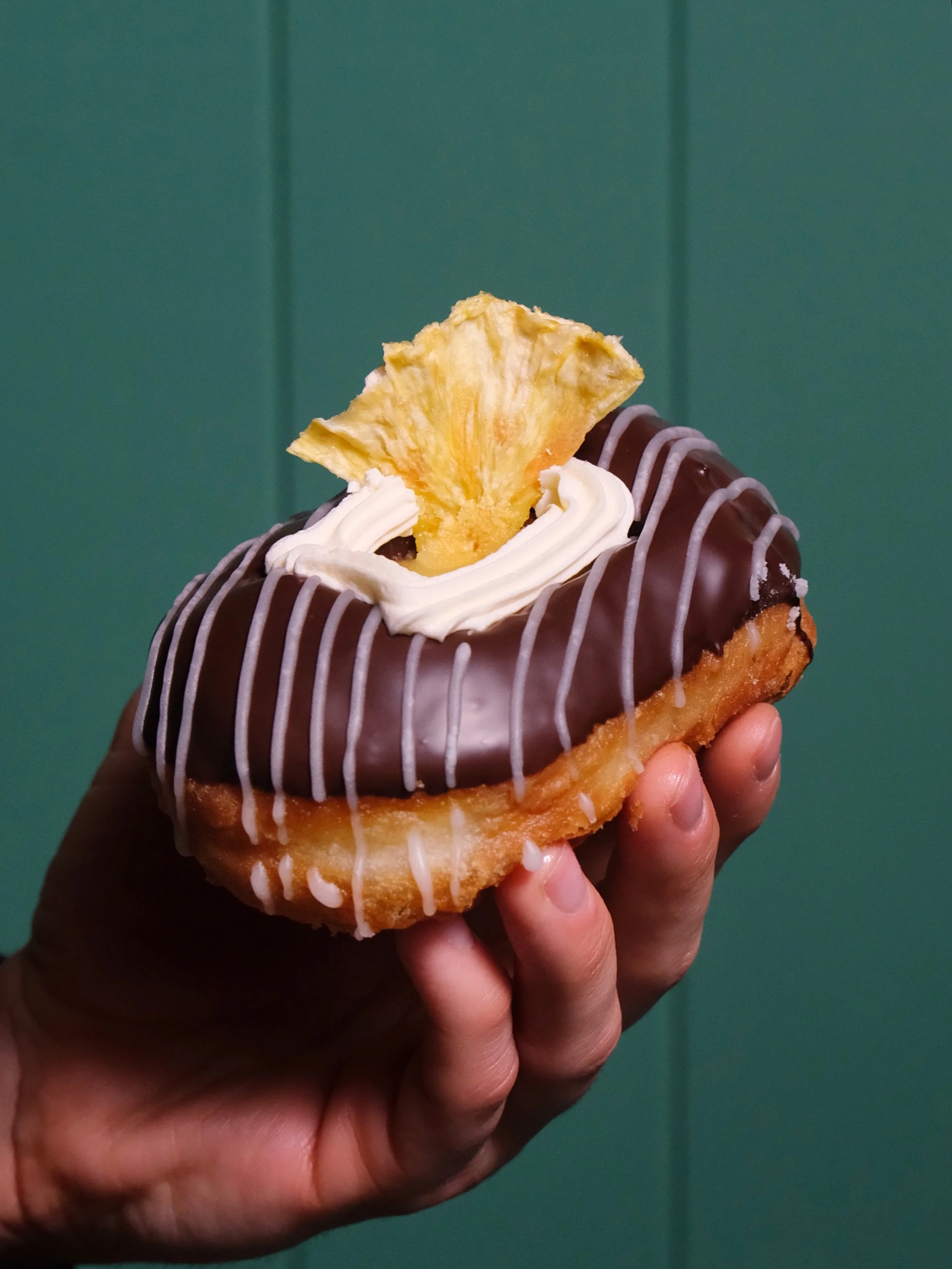 PINEAPPLE LUMP - NEW DONUT! 🍍🧡
For the month of October only. 

We coated one of our pillowy donuts in Whittakers dark chocolate, then filled it with the zingiest house-made pineapple curd and pineapple cream, and finished it with buttercream and f