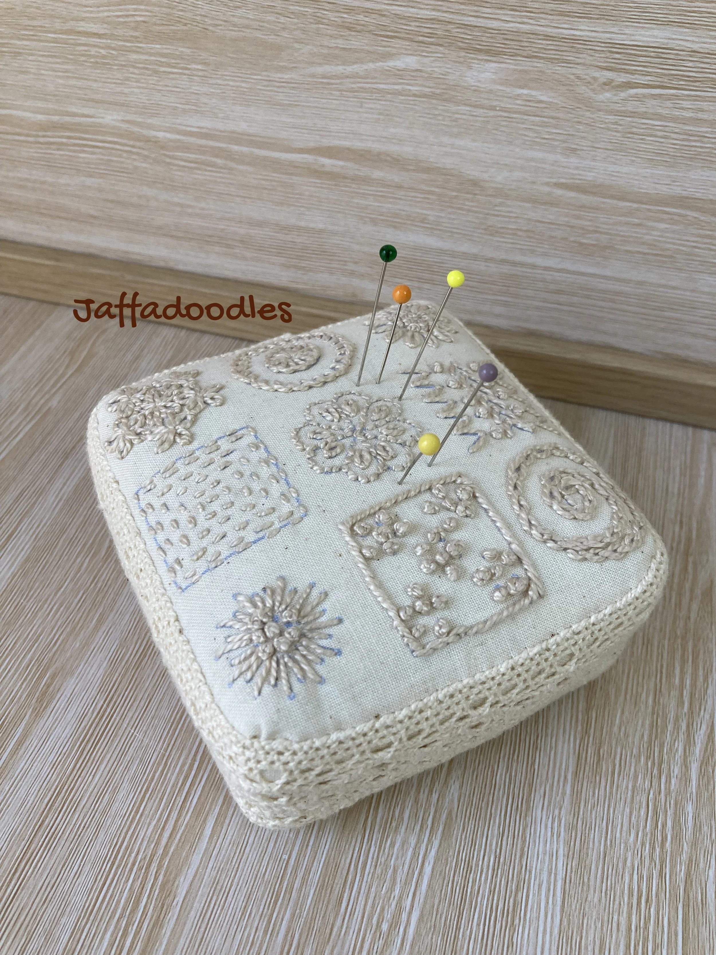 Square calico pin cushion.