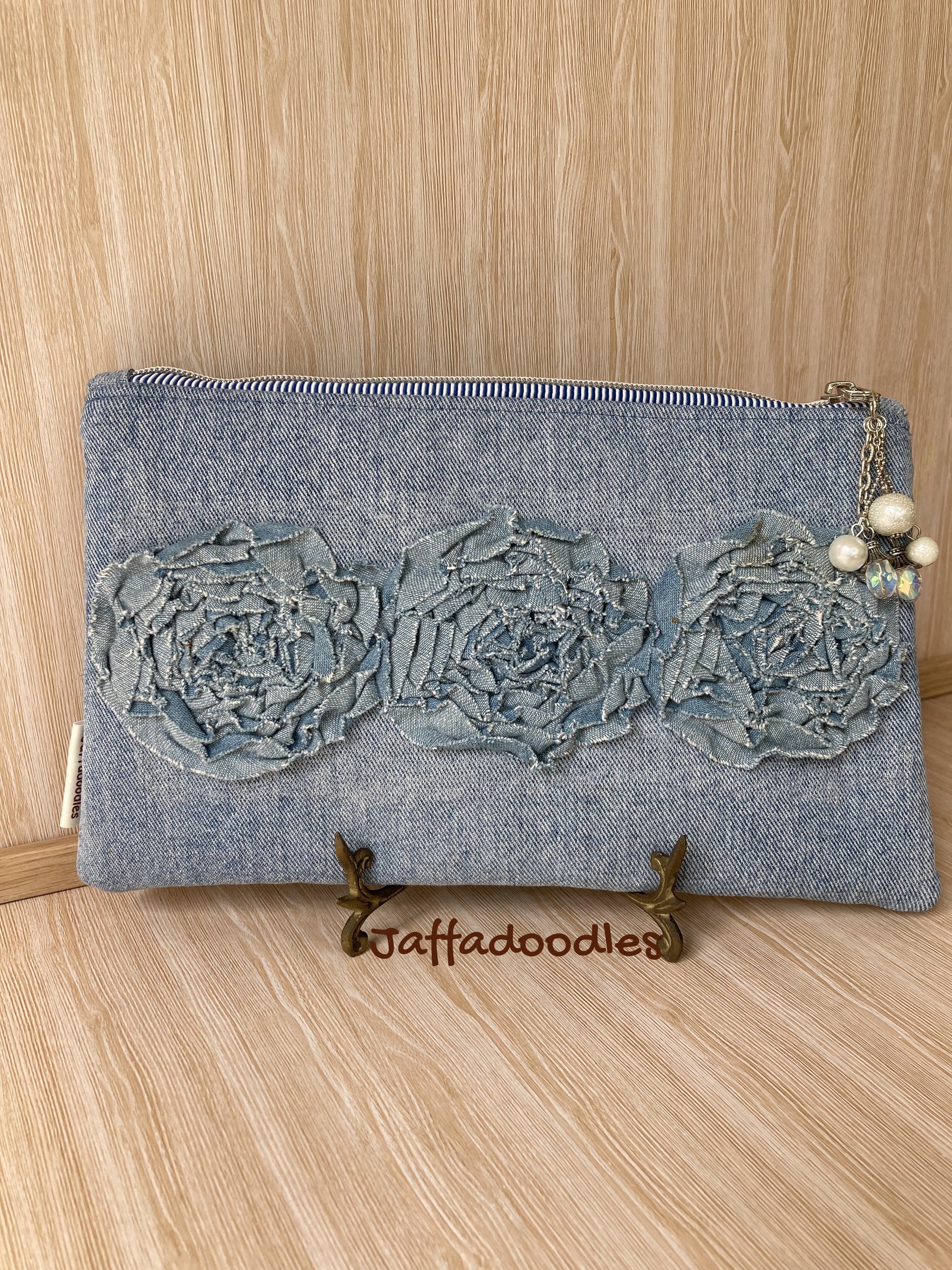 Denim "rose" clutch.