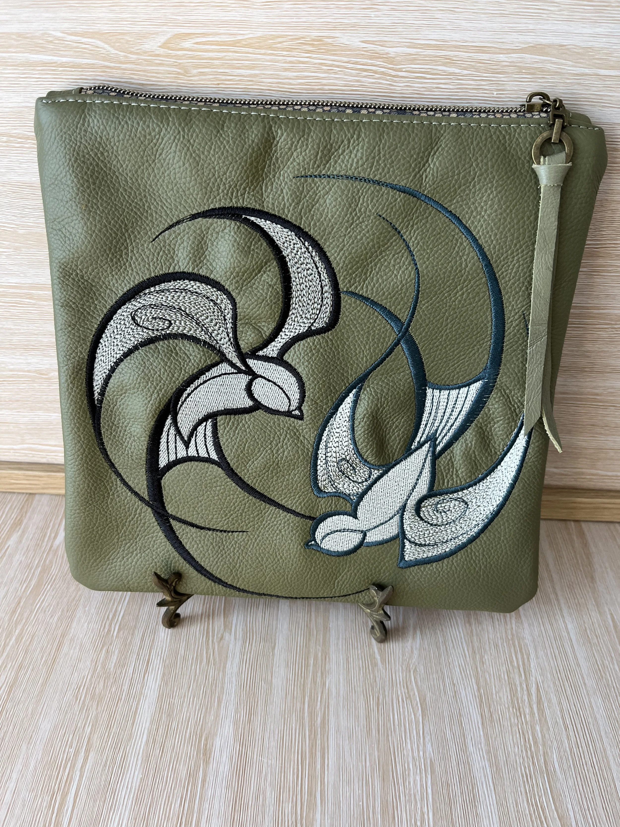 Leather embroidered clutch.