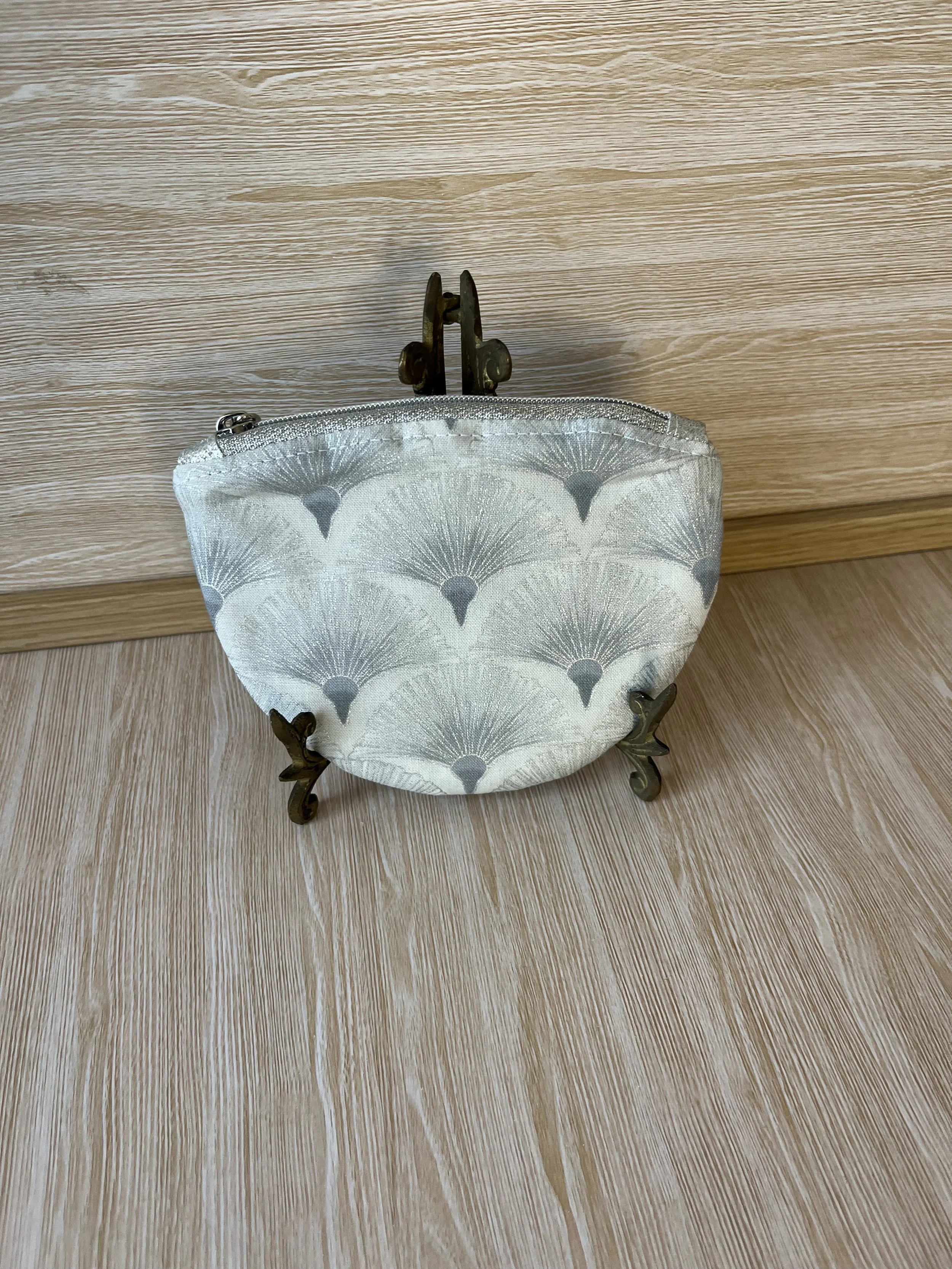 Small silver zipper pouch.