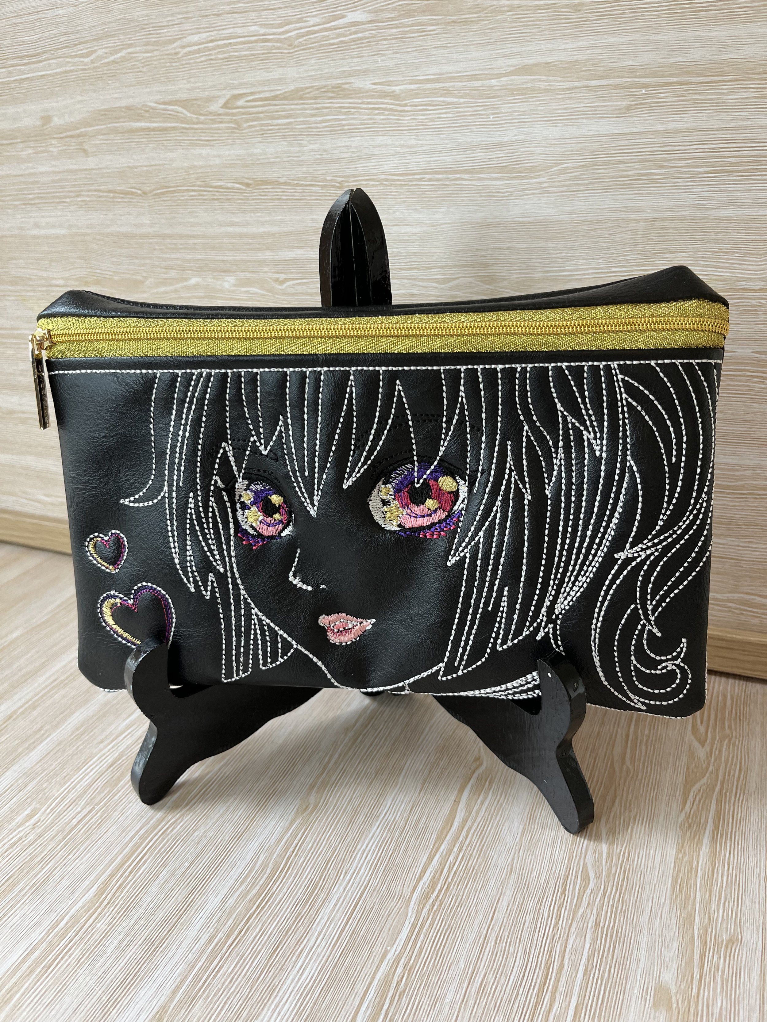 Black faux leather Anime pouch.