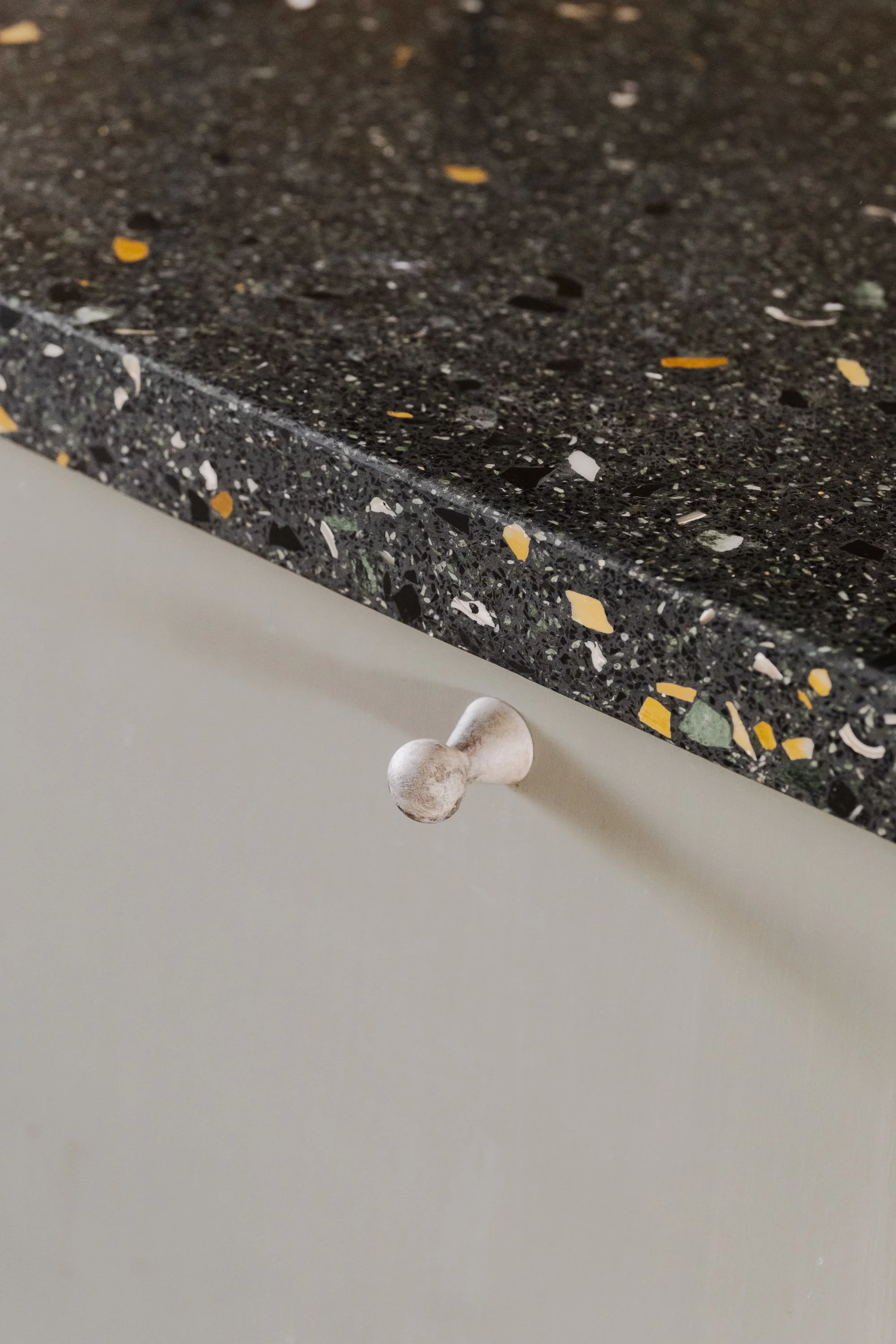 toby-robinson-interior-design-amsterdam-apartment-kitchen-terrazzo-top-ceramic-knob.jpg