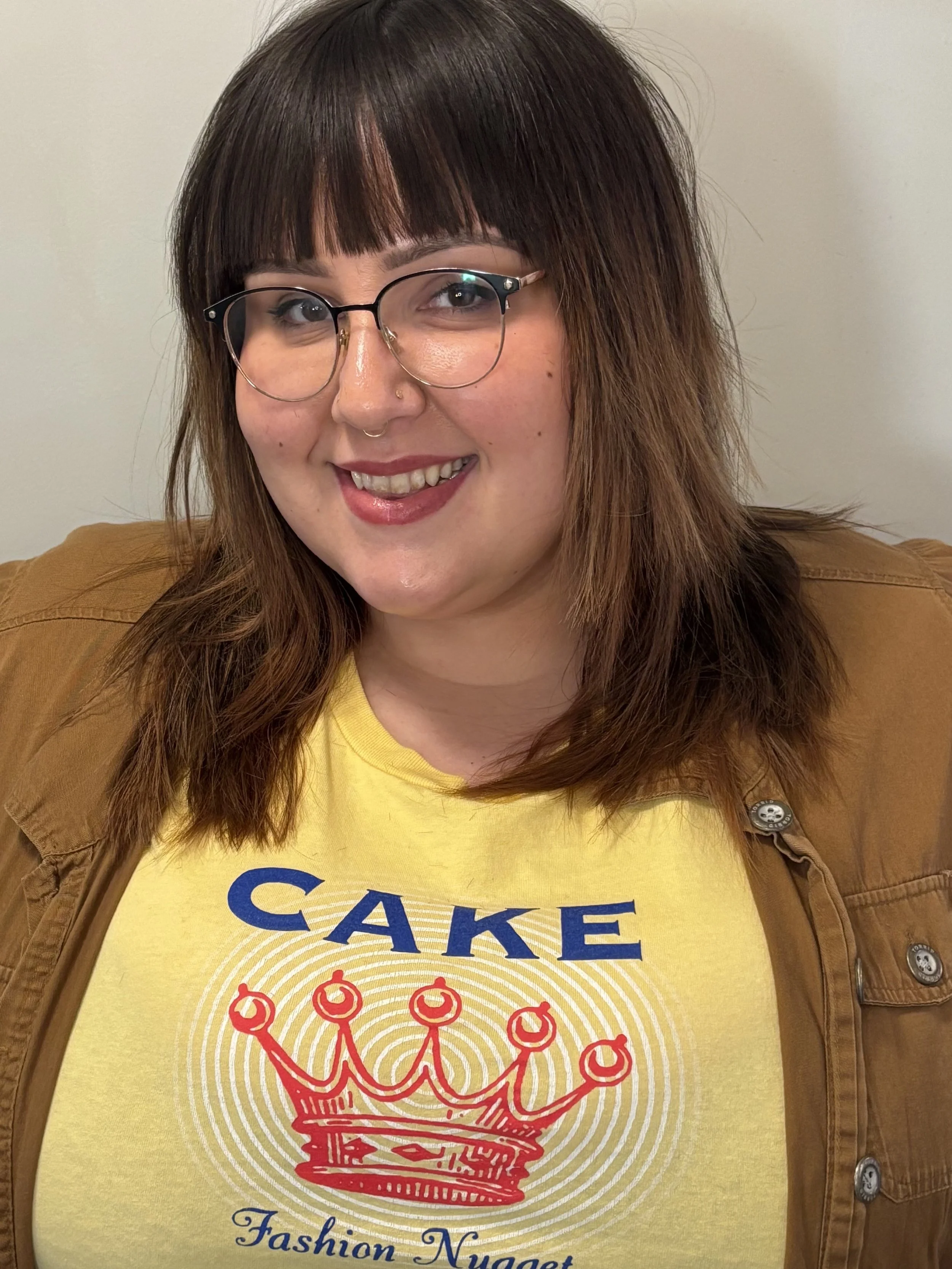 Shoulder-length brown hair with bangs.