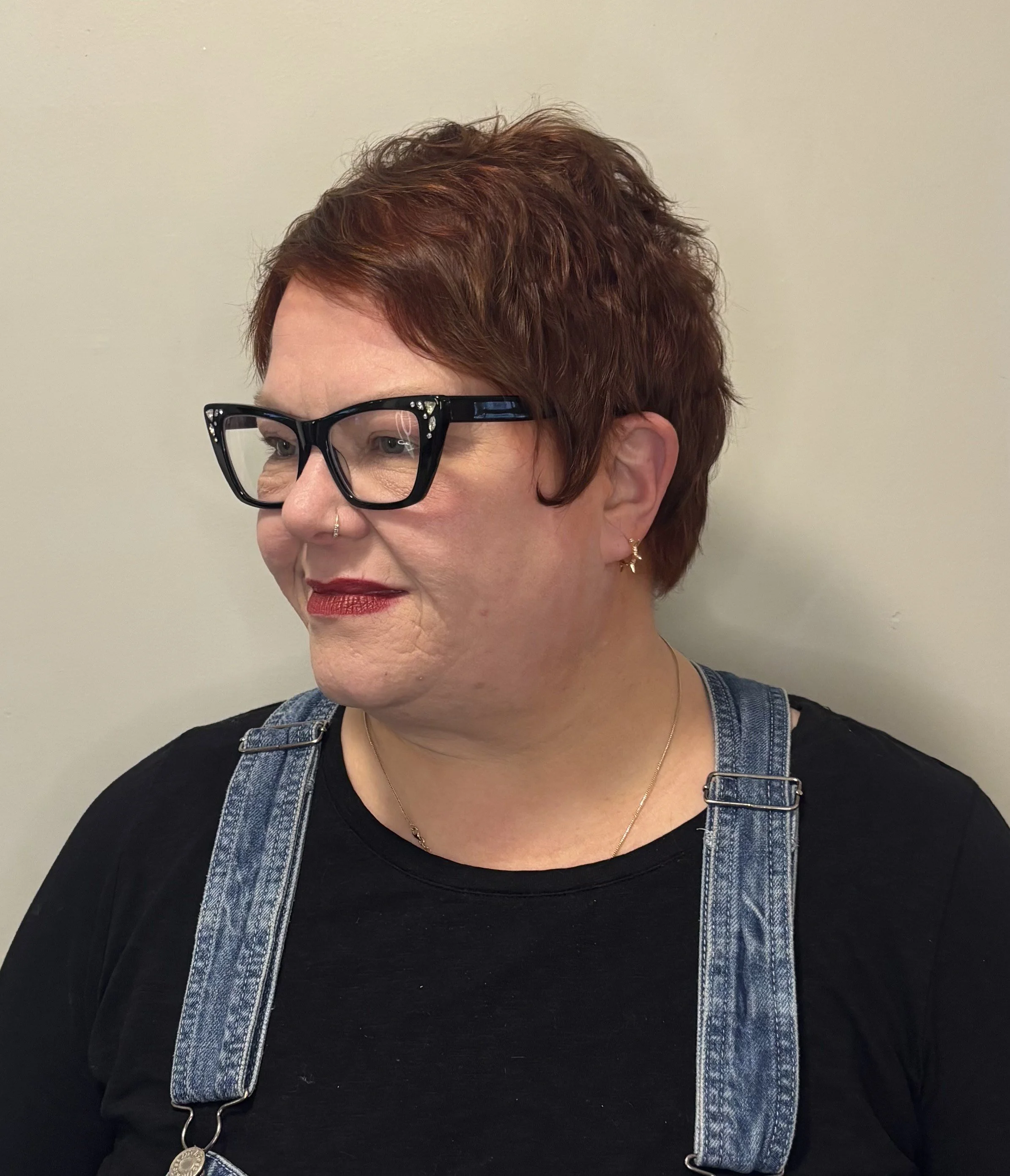 Short, reddish-brown hair cut.