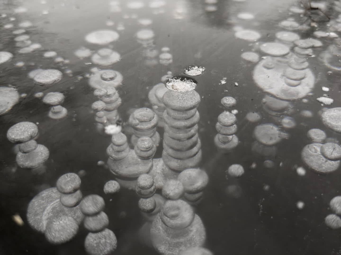 Staring down into the darkness, the abstract shapes look like infinite galaxies. When I found these bubbles frozen in the ice I was in awe of nature. These perfectly round shapes were mesmerizing, we can I believe learn so much from the land and the